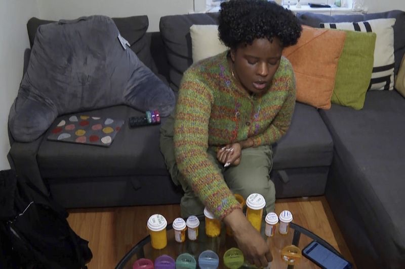 Jazmin Evans, a student at Temple University, prepares her post-kidney transplant medications at home in Philadelphia on Feb. 16.