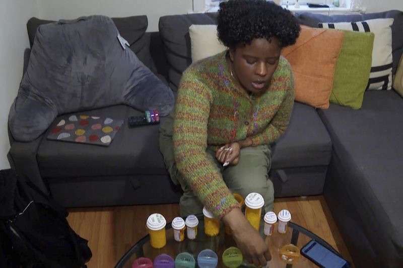 Jazmin Evans, a student at Temple University, prepares her post-kidney transplant medications at home in Philadelphia on Feb. 16.