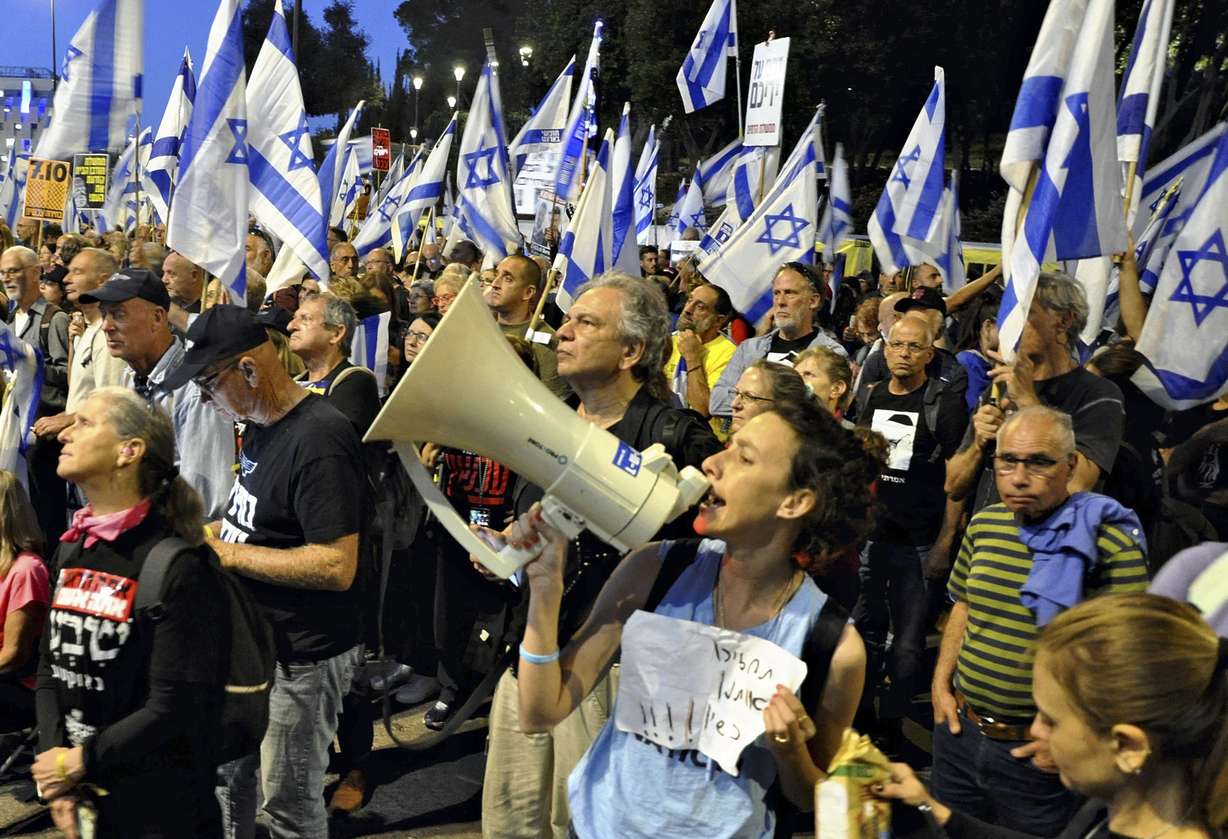People protest against Israeli Prime Minister Benjamin Netanyahu's government outside the Knesset, Israel's parliament on Sunday.