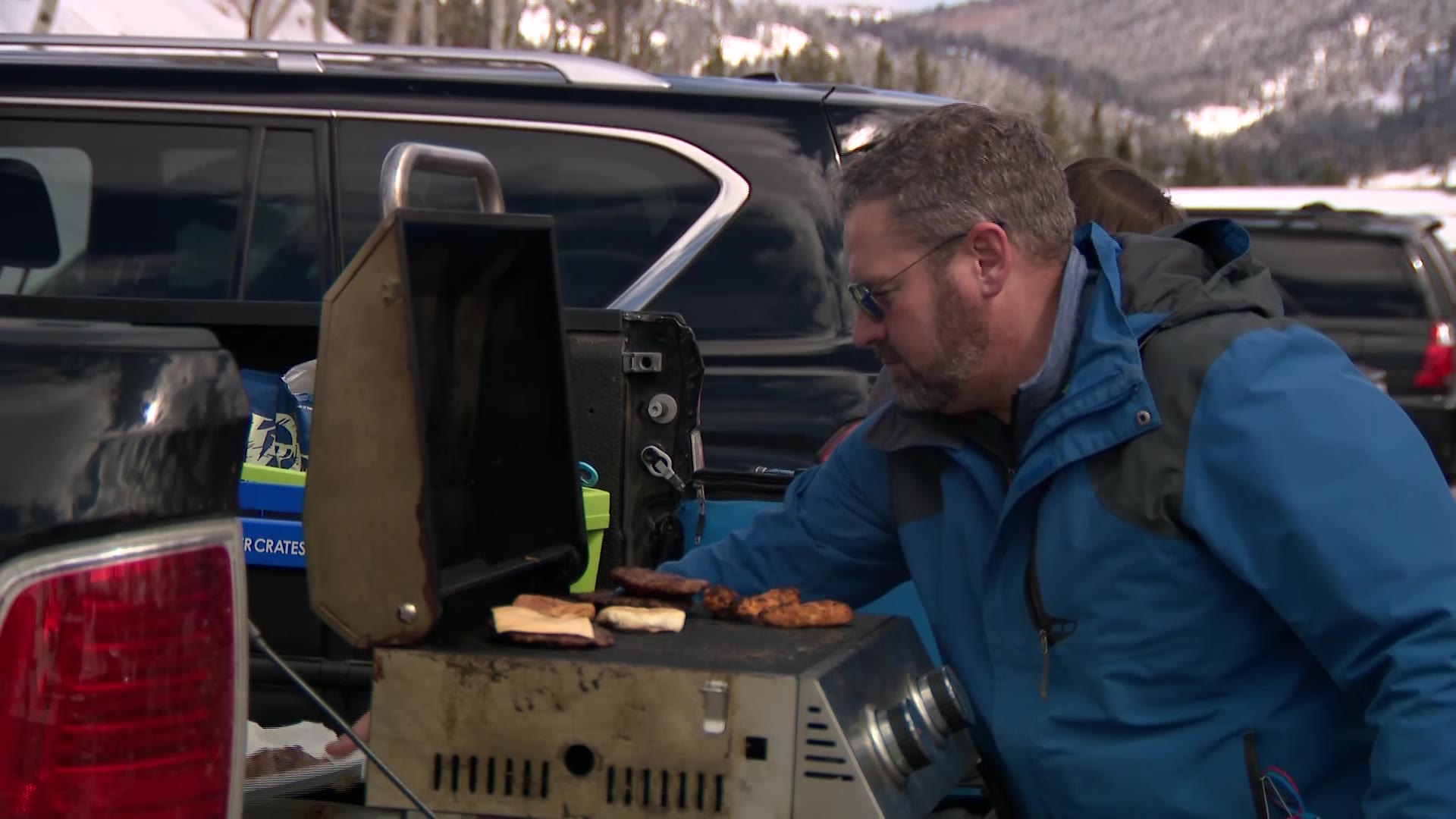 Shane Robertson cooks some burgers in the parking lot of the resort. The gloomy, wet Easter Sunday turned into a solid ski day Monday at some of Utah’s resorts, including Beaver Mountain.