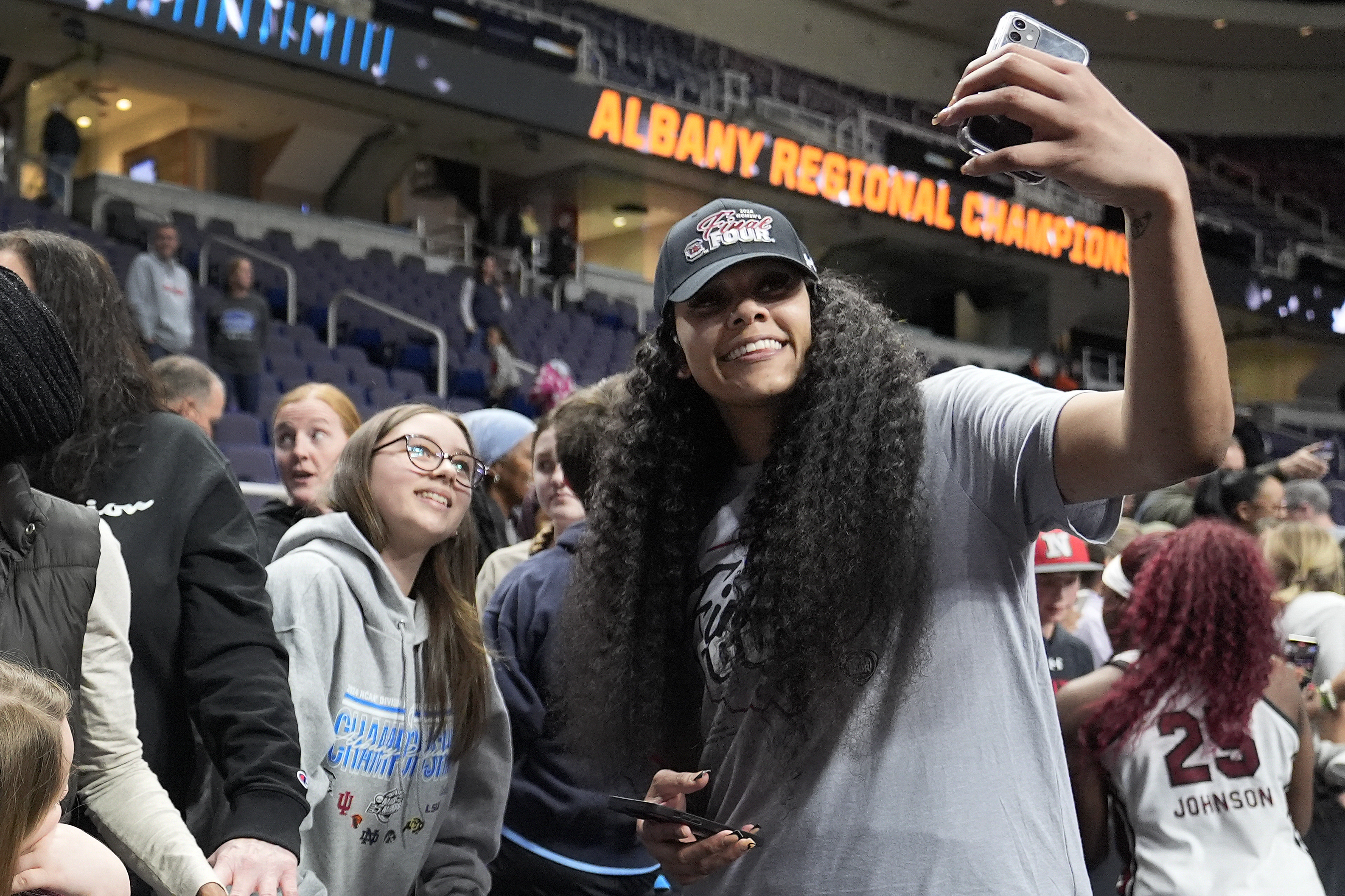 South Carolina center Kamilla Cardoso (10) takes a selfie with a fan after defeating Oregon State in an Elite Eight round college basketball game during the NCAA Tournament, Sunday, March 31, 2024, in Albany, N.Y.