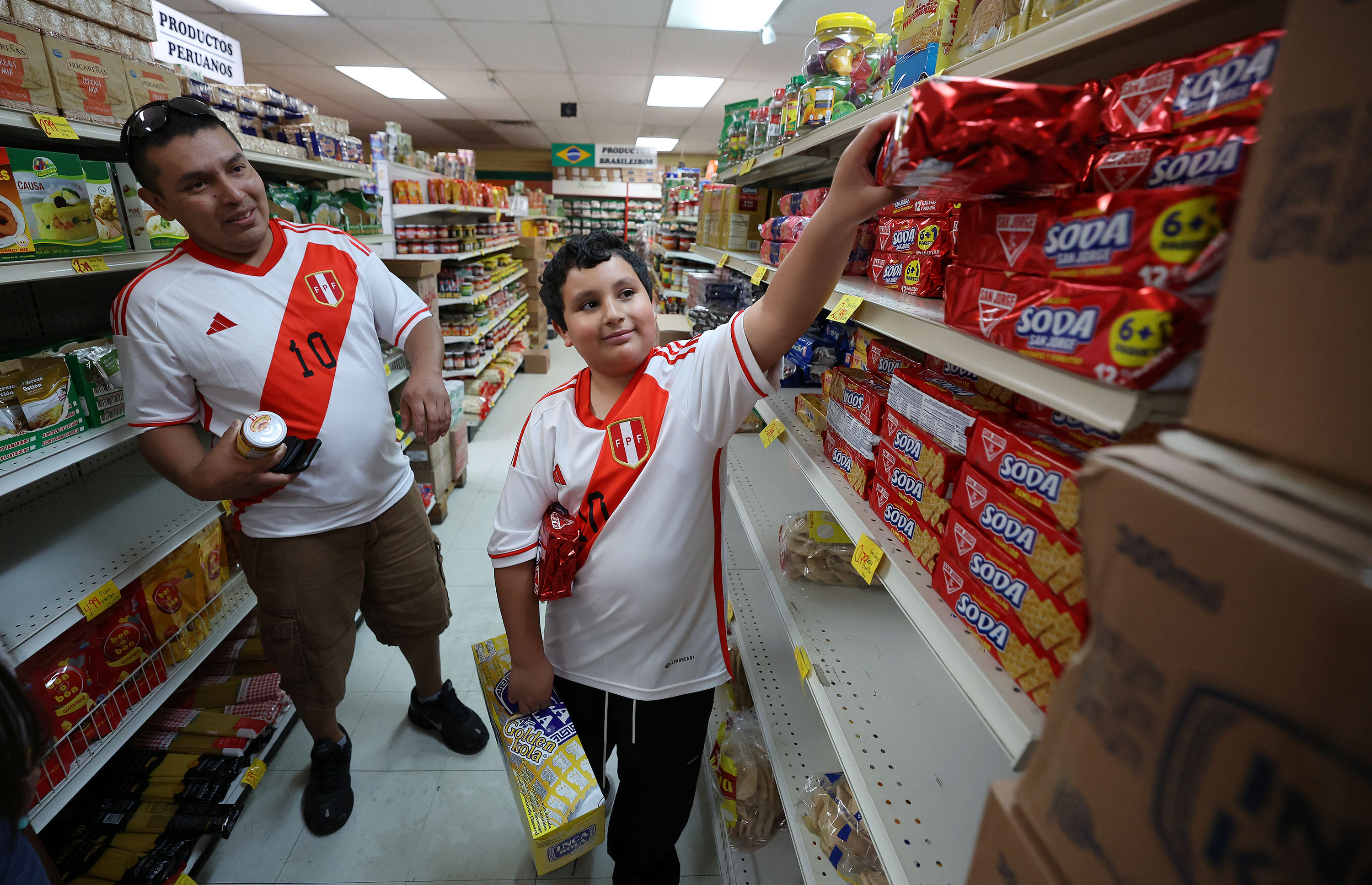 Oswaldo Briceño and his son James wear Peruvian soccer jerseys as they shop at La Pequeñita International Market in South Salt Lake on Monday. Peru is to open a consulate in Salt Lake City.