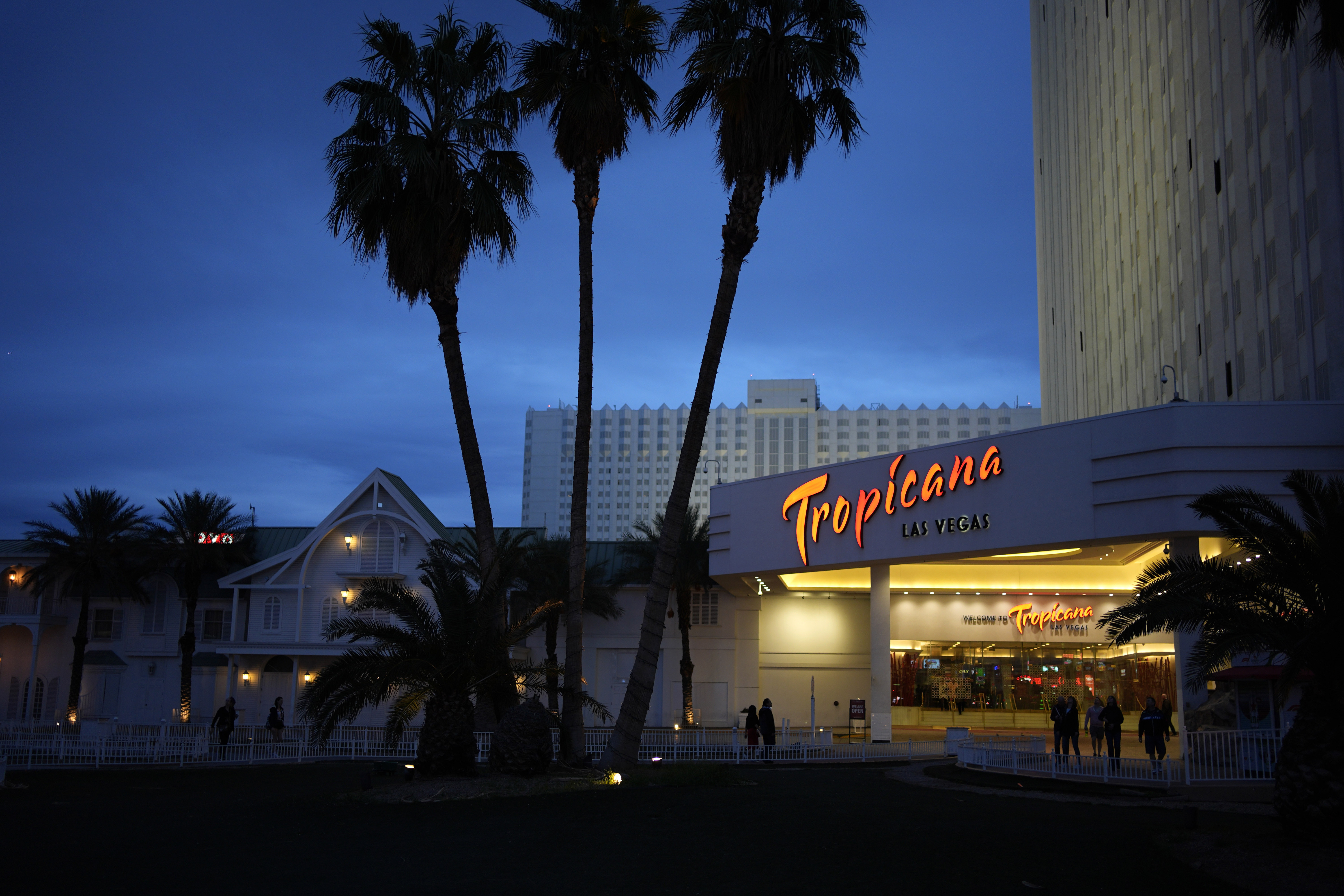 People walk outside of the Tropicana hotel-casino March 28 in Las Vegas. The property is scheduled to close Tuesday.