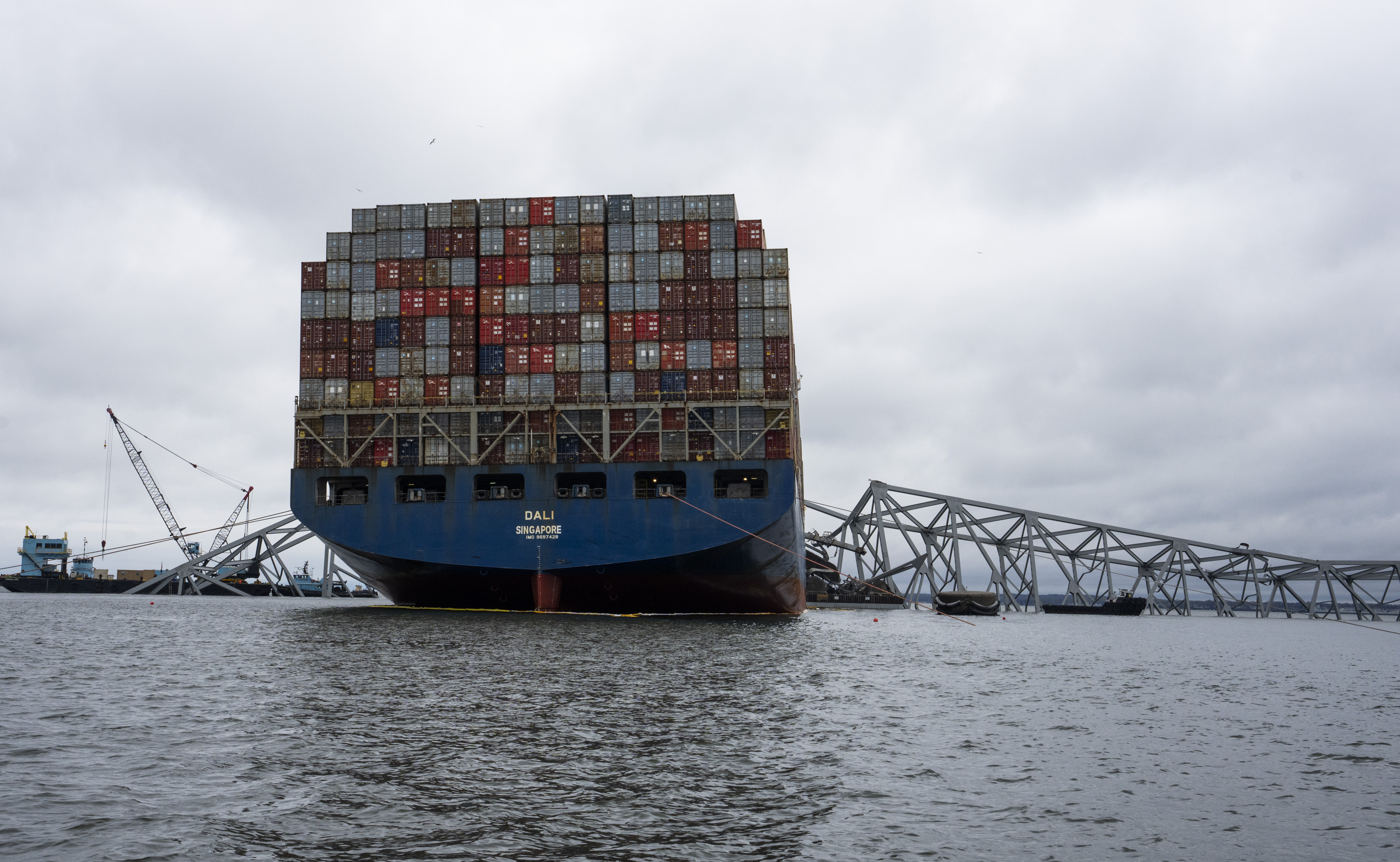 The Dali, a massive container ship from Singapore, still sits amid the wreckage and collapse of the Francis Scott Key Bridge in the Baltimore port, Monday.