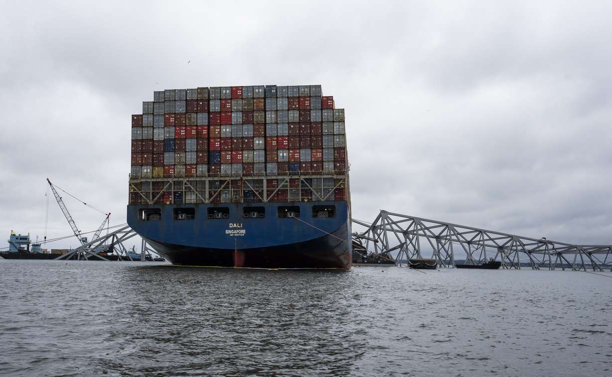 The Dali, a massive container ship from Singapore, still sits amid the wreckage and collapse of the Francis Scott Key Bridge in the Baltimore port, Monday.