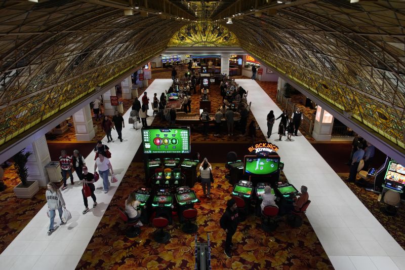 People walk through the casino floor at the Tropicana hotel-casino March 29, in Las Vegas. The property closed Tuesday.