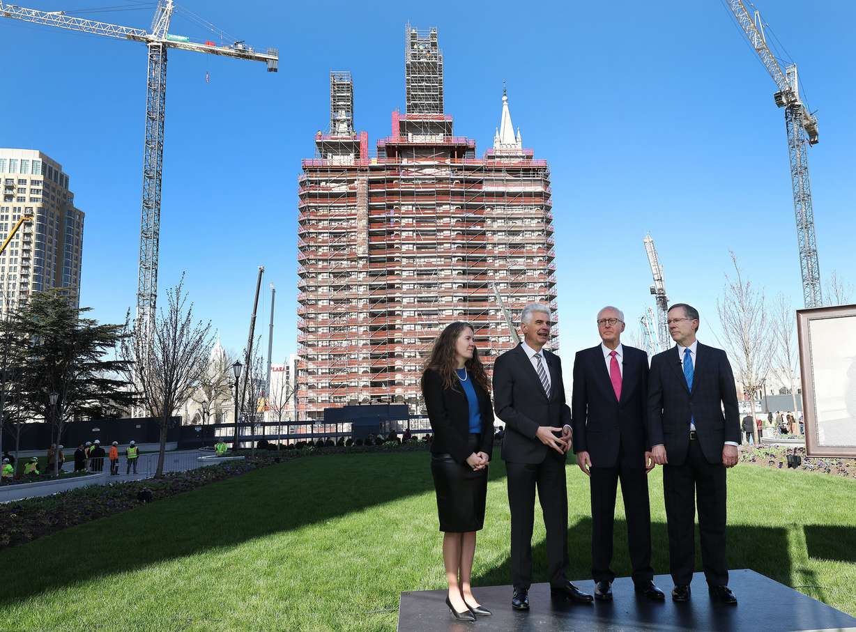 Bishop Gérald Caussé, Emily Utt, Elder Larry Wilson and Mark Woodruff speak prior to the Angel Moroni being raised atop the Salt Lake Temple in Salt Lake City on Tuesday.