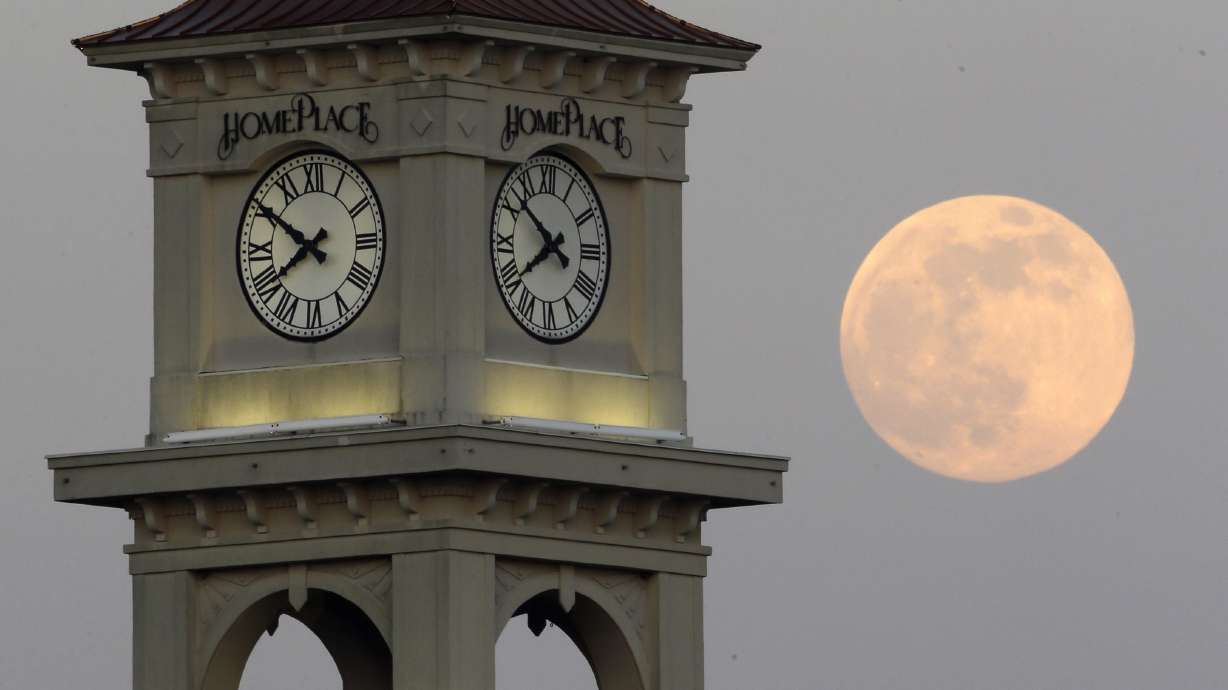 The moon rises behind the Home Place clock tower in Prattville, Ala., June 22, 2013. NASA wants to come up with a way to track time on the moon.