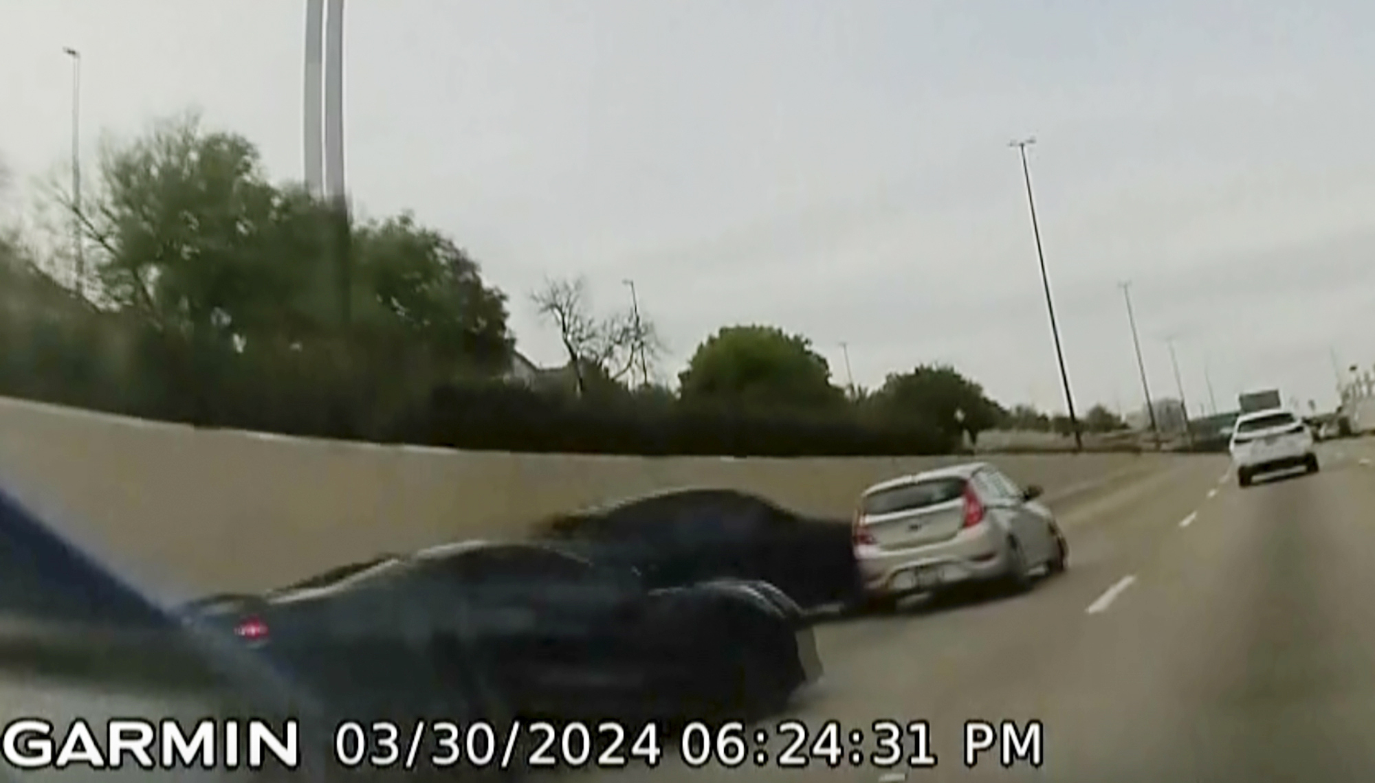 In this screen grab taken from dash camera video provided by Bill Nabors, two speeding sports cars, left and second from left, cause a chain-reaction crash on the North Central Expressway, in Dallas, Saturday, March 30, 2024. 
