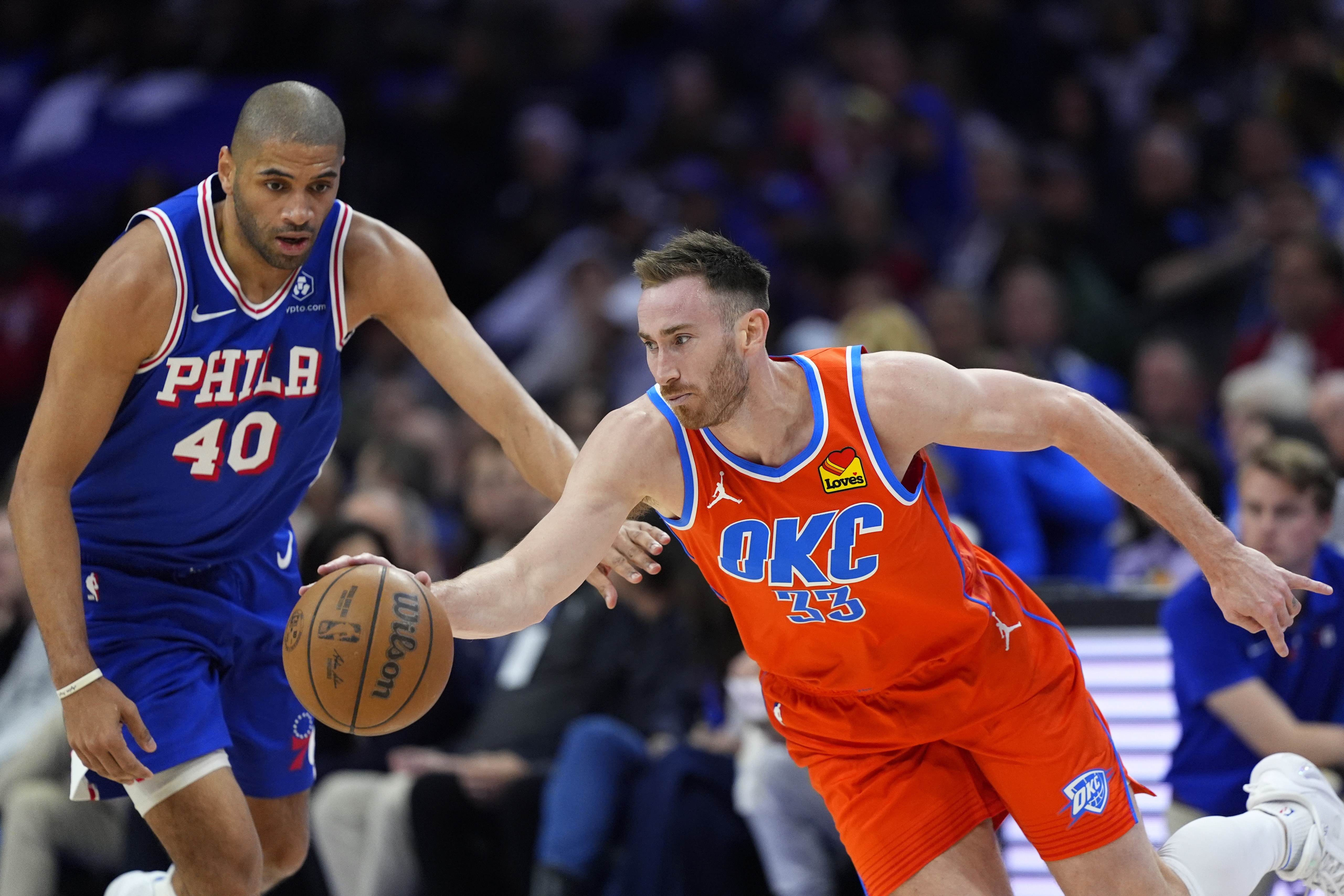 Oklahoma City Thunder's Gordon Hayward, right, tries to get past Philadelphia 76ers' Nicolas Batum during the first half of an NBA basketball game, Tuesday, April 2, 2024, in Philadelphia.