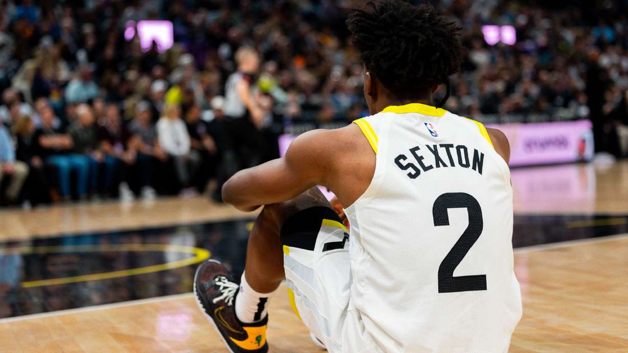 Utah Jazz guard Collin Sexton (2) sits on the ground after falling down as play continues during the NBA game between the Utah Jazz and the Cleveland Cavaliers at the Delta Center in Salt Lake City on Tuesday, April 2, 2024.