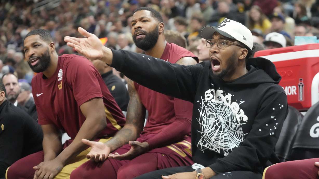 Cleveland Cavaliers guard Donovan Mitchell, right, reacts to a call while sitting on the bench during the first half of an NBA basketball game against the Utah Jazz Tuesday, April 2, 2024, in Salt Lake City.