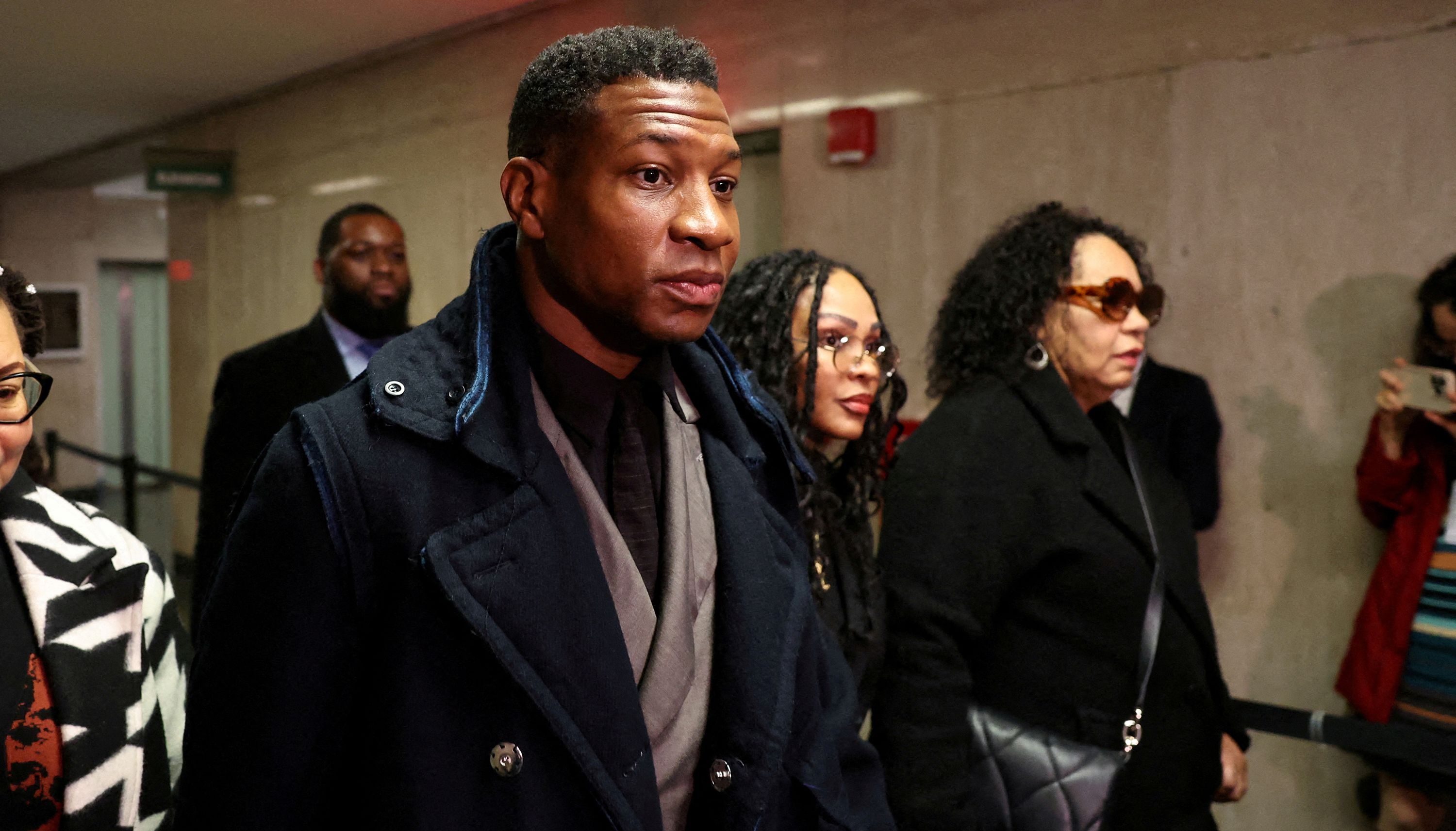Actor Jonathan Majors arrives with Meagan Good for the jury selection in his assault and harassment case at Manhattan Criminal Court in New York City on Dec. 18, 2023. A judge has ruled the conviction will stand.