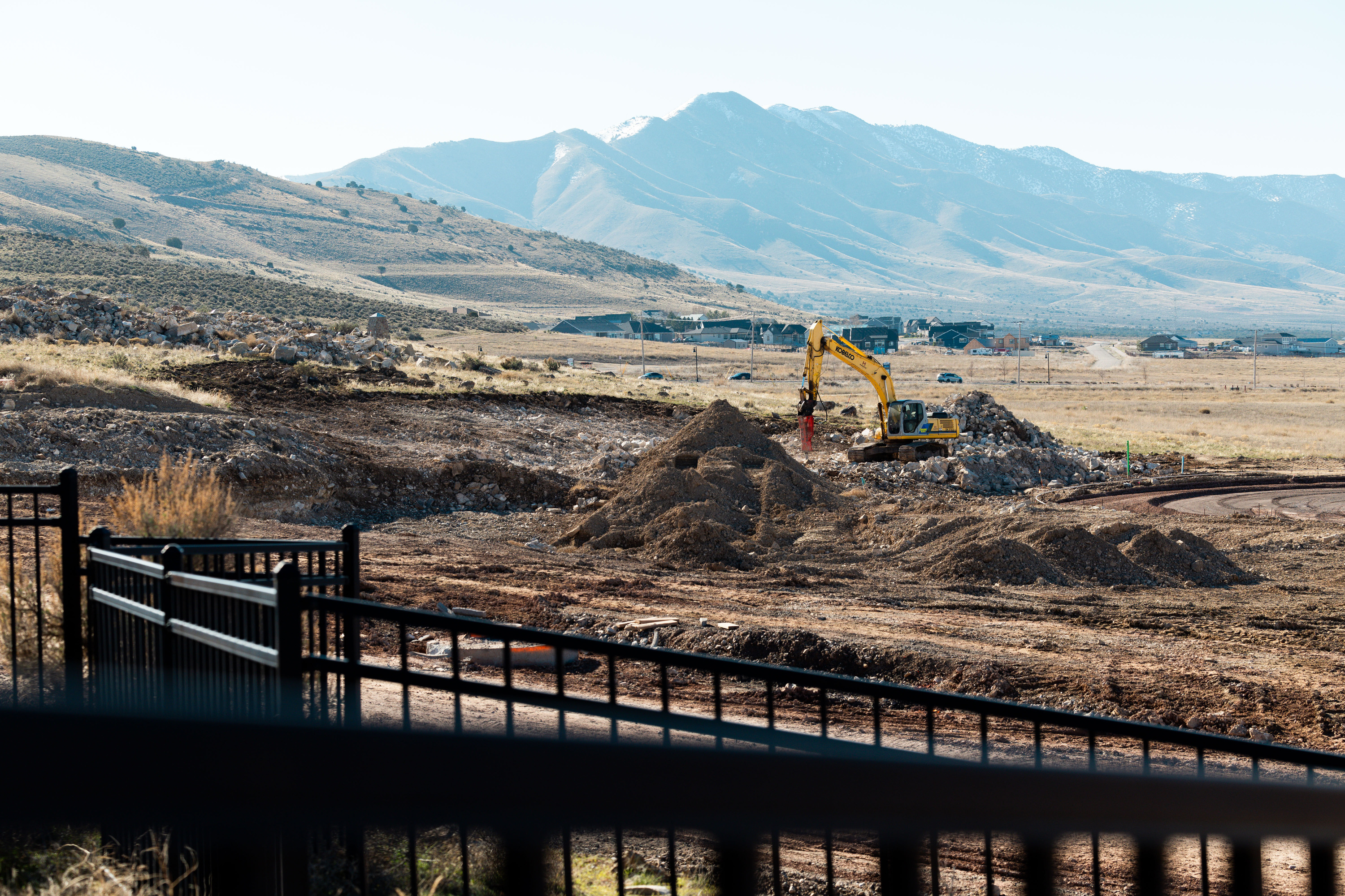 Fences are built around rocks with petroglyphs to protect them as development continues in Eagle Mountain on Wednesday. The city of Eagle Mountain has tried to work together with private landowners and developers to preserve the scattered petroglyphs despite continued development in the fast-growing area.