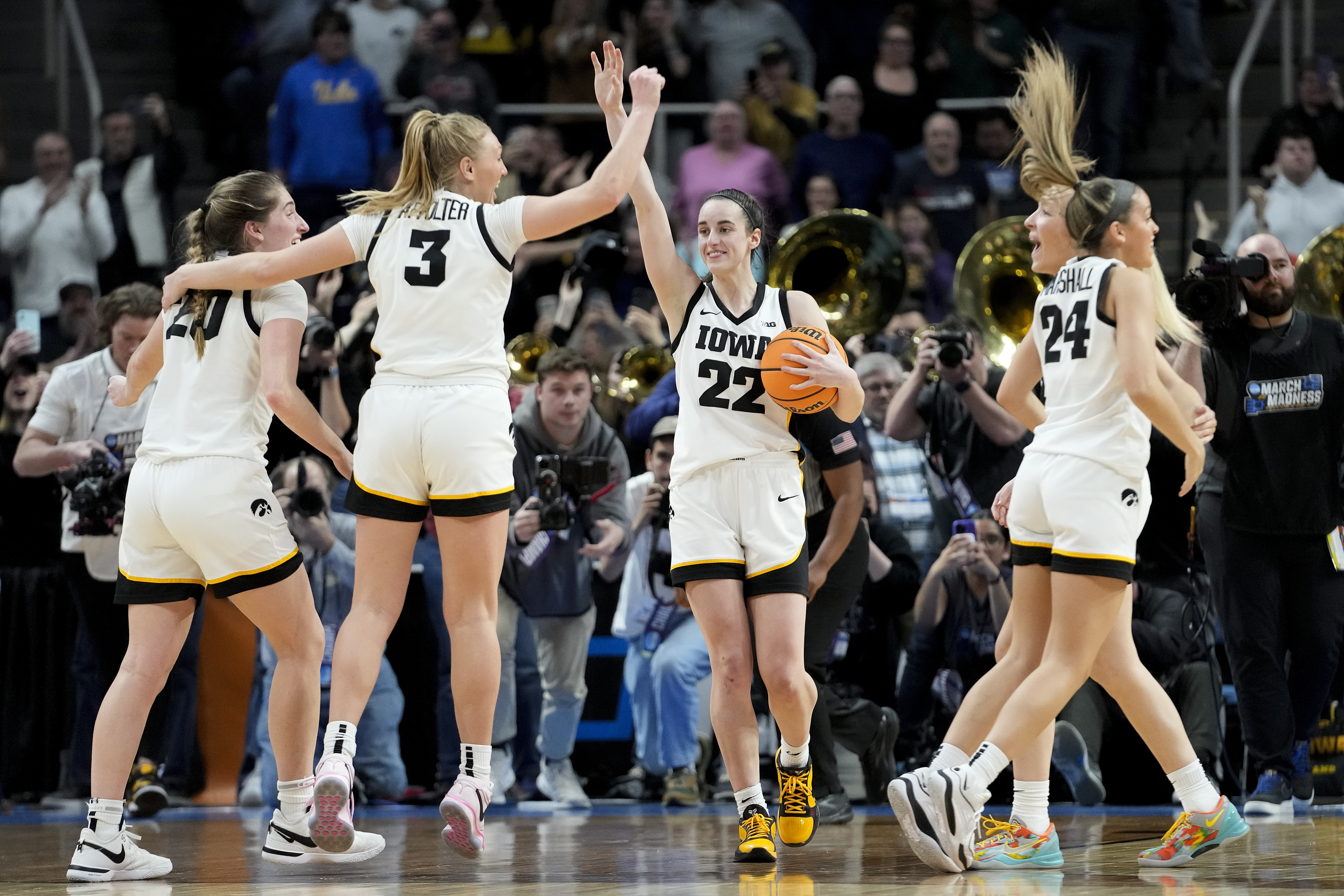 Iowa guard Caitlin Clark (22) celebrates with teammates after defeating LSU in an Elite Eight round college basketball game during the NCAA Tournament, Monday, April 1, 2024, in Albany, N.Y. 