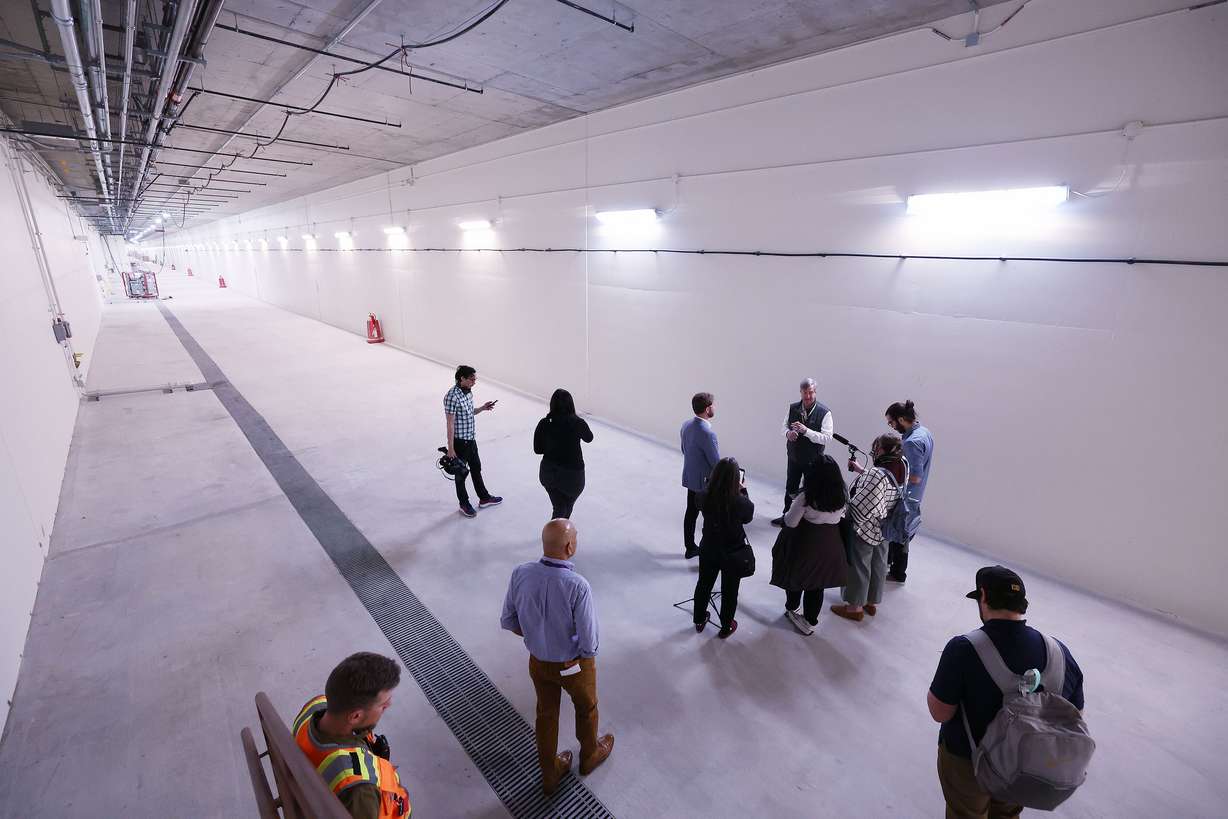 Media members look over the future Salt Lake City International Airport’s train tunnel in Salt Lake City on Wednesday.