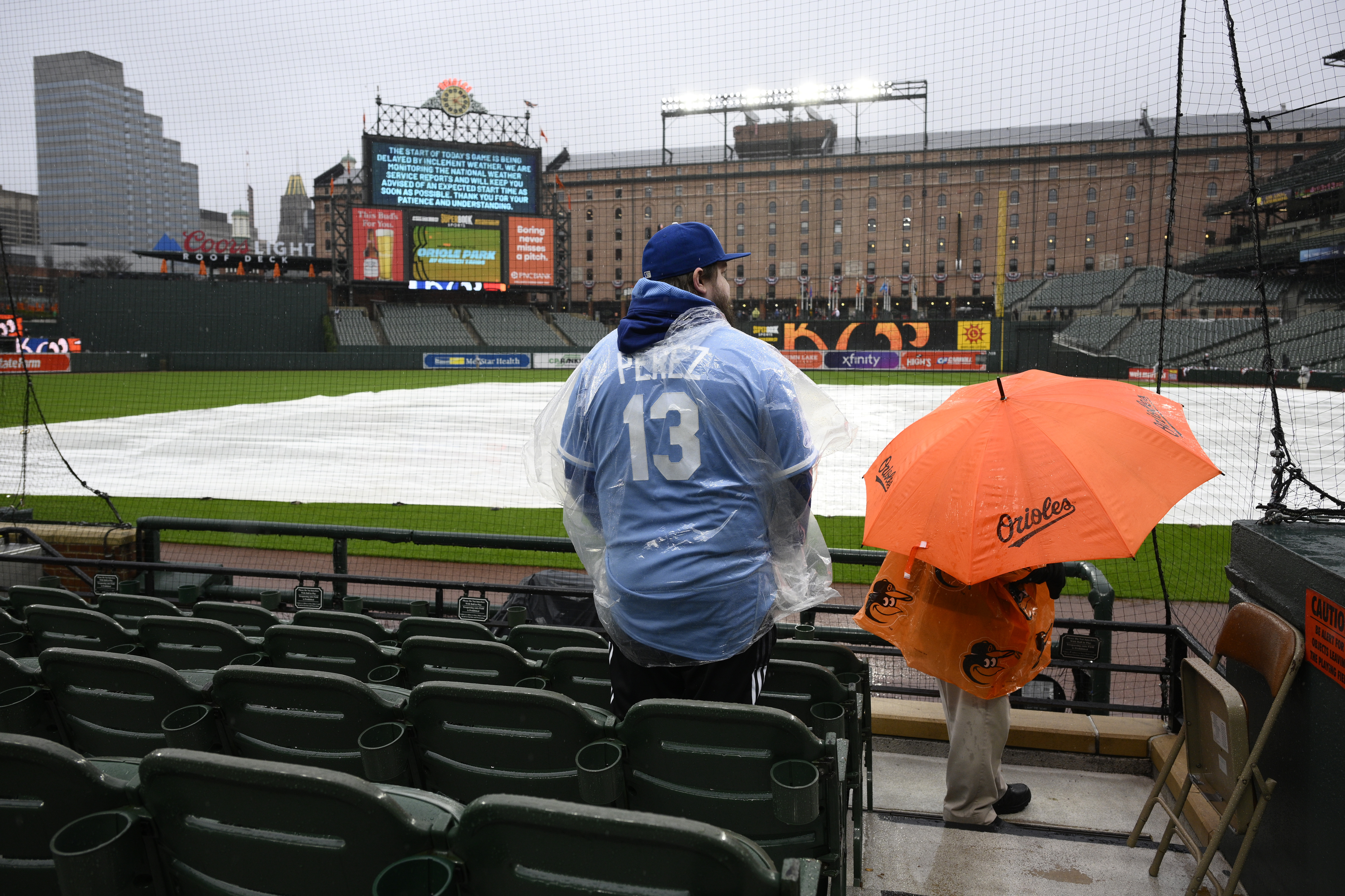 Charlie Slaybaugh of Kansas City, Mo., waits out a rain delay before a baseball game between the Baltimore Orioles and the Kansas City Royals, Wednesday, April 3, 2024, in Baltimore. 