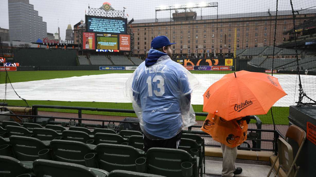 Charlie Slaybaugh of Kansas City, Mo., waits out a rain delay before a baseball game between the Baltimore Orioles and the Kansas City Royals, Wednesday, April 3, 2024, in Baltimore.