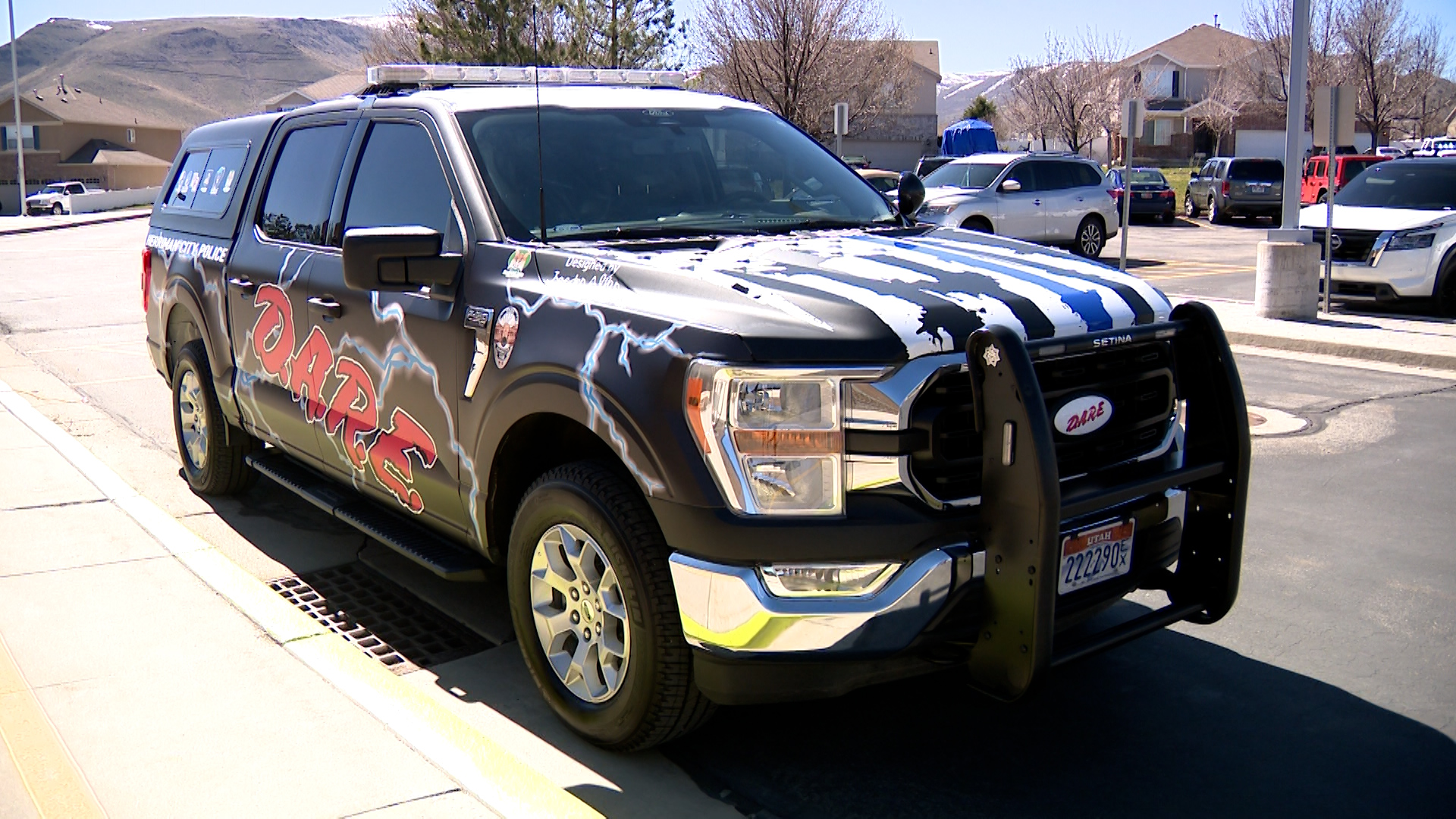 A police car is covered with fifth-grader Jaeden’s design which includes lightning bolts.