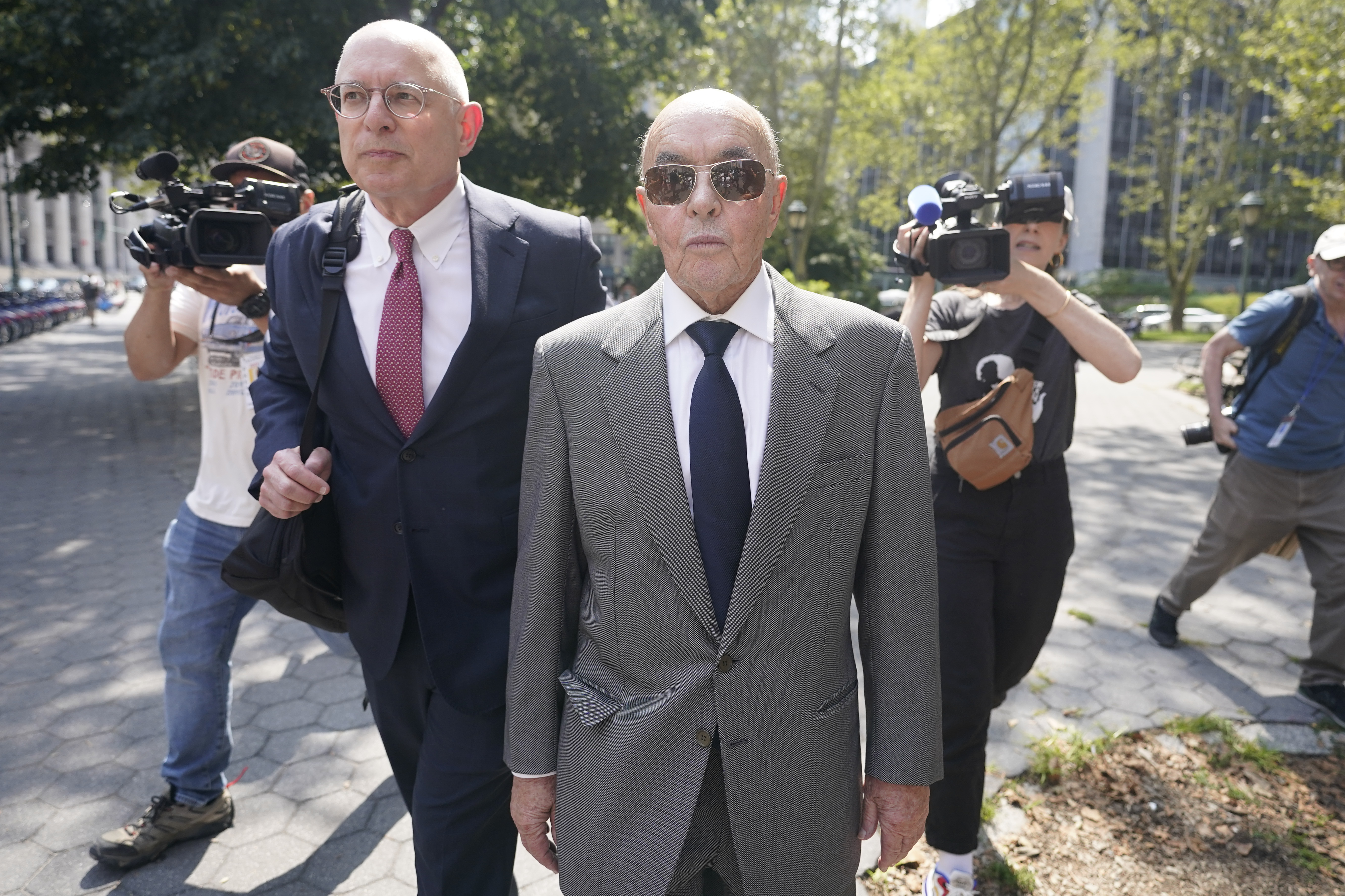 FILE - British billionaire Joe Lewis leaves, center, Manhattan federal court, Wednesday, July 26, 2023, in New York. Lewis, whose family trust owns the Tottenham Hotspur soccer club, is set to be sentenced Thursday, April 4, 2024, after pleading guilty to insider trading and conspiracy charges in New York. Prosecutors say in court documents that his age, medical issues and willingness to come to America to face criminal charges have earned him leniency.. 