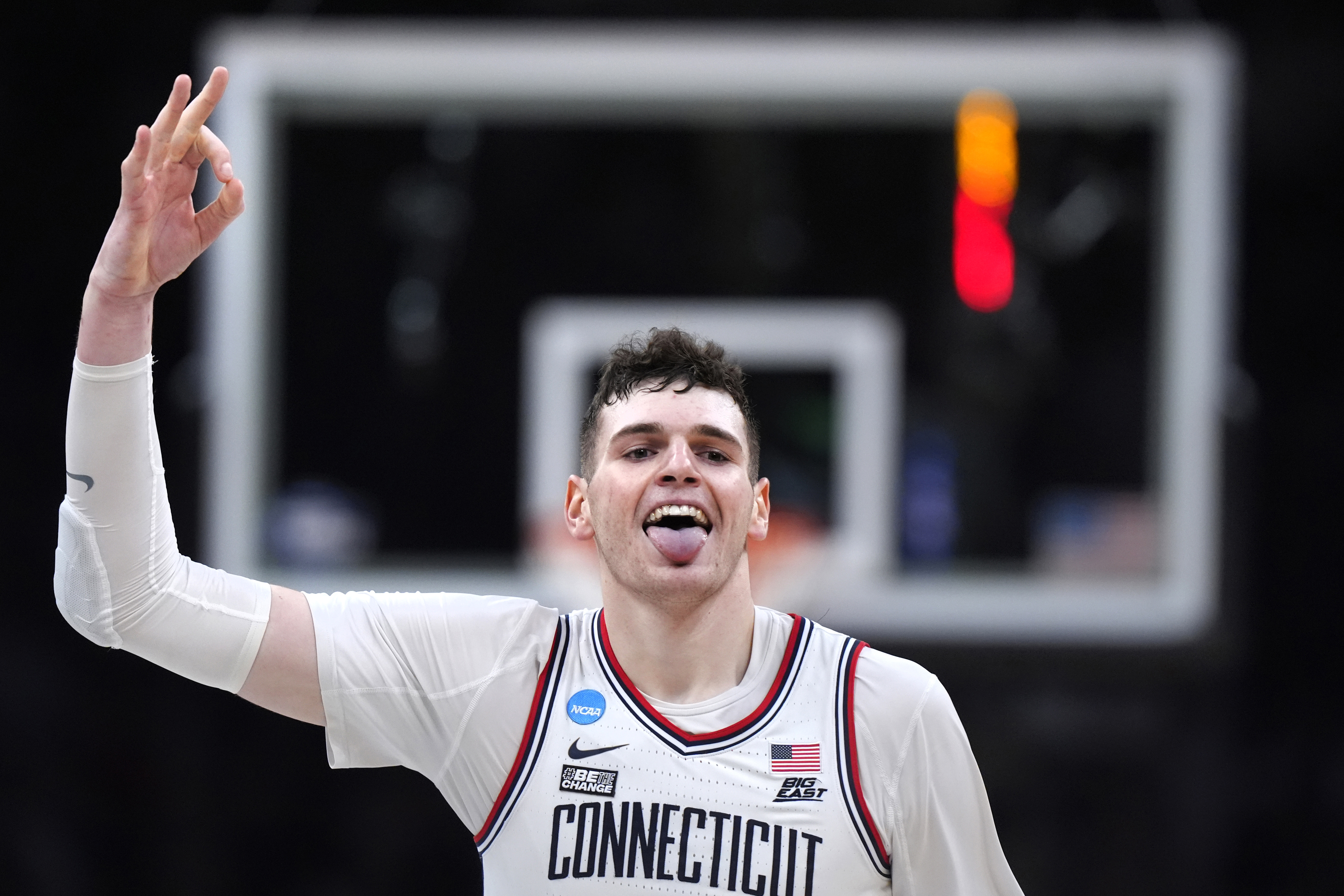 UConn center Donovan Clingan (32) celebrates after hitting a 3-pointer against Illinois during the second half of the Elite 8 college basketball game in the men's NCAA Tournament, Saturday, March 30, 2024, in Boston. 