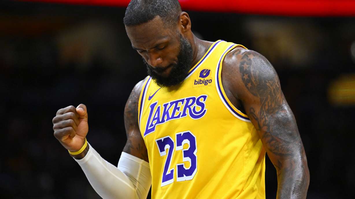 Los Angeles Lakers forward LeBron James clenches his fist after scoring against the Washington Wizards during the first half of an NBA basketball game Wednesday, April 3, 2024, in Washington.