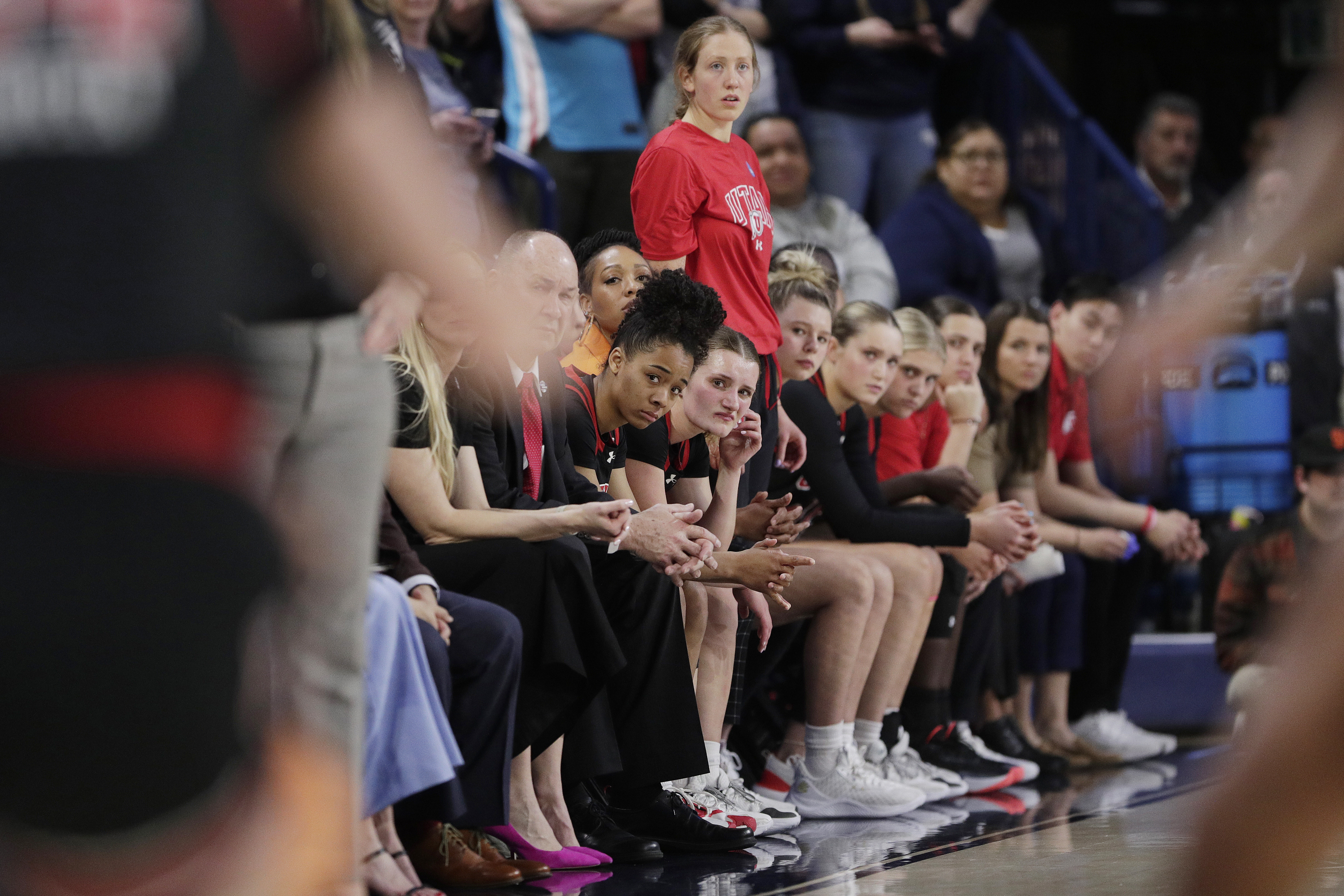 Players and staff on the Utah bench react during a second-round game against Gonzaga in the NCAA Tournament in Spokane, Wash., March 25. Police investigating racist incidents directed toward the Utah women's basketball team say they've found an audio recording in which the use of a racial slur was clearly audible.