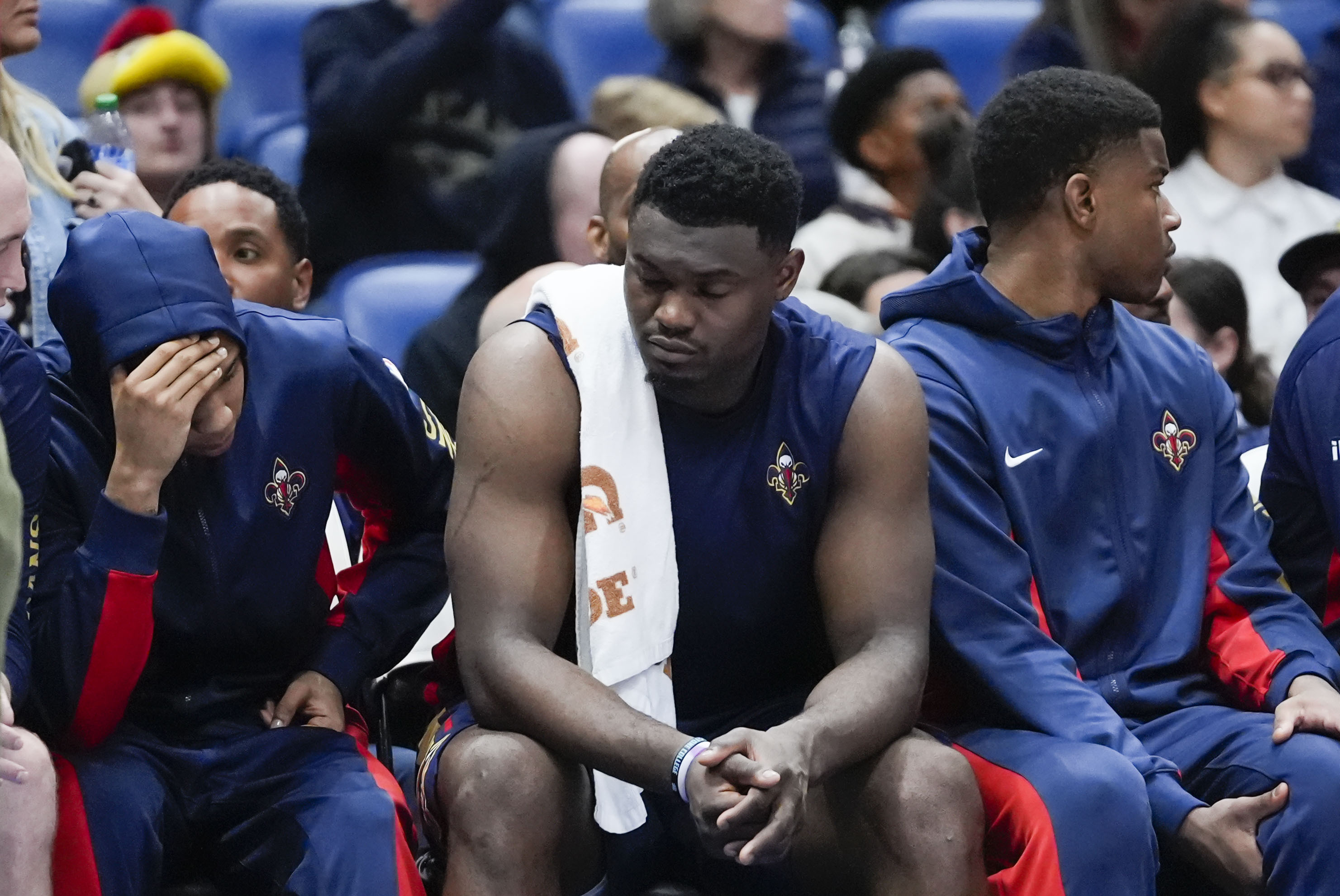 New Orleans Pelicans guard Jordan Hawkins, left, forward Zion Williamson and forward E.J. Liddell react from the bench in the second half of an NBA basketball game against the Orlando Magic in New Orleans, Wednesday, April 3, 2024. The Magic won 117-108.