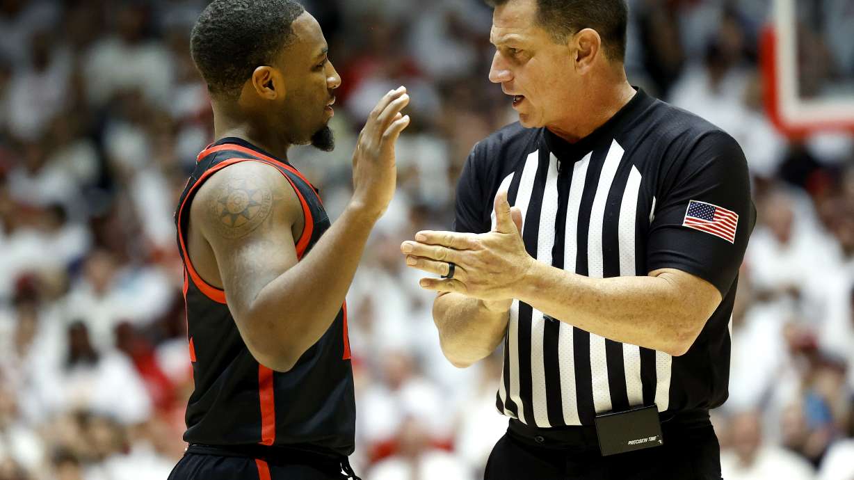 San Diego State guard Darrion Trammell argues with official Mike Littlewood during game against New Mexico, Jan. 13. in Albuquerque, N.M. Littlewood a former BYU baseball coach, recently returned from officiating Sweet 16 games last weekend.