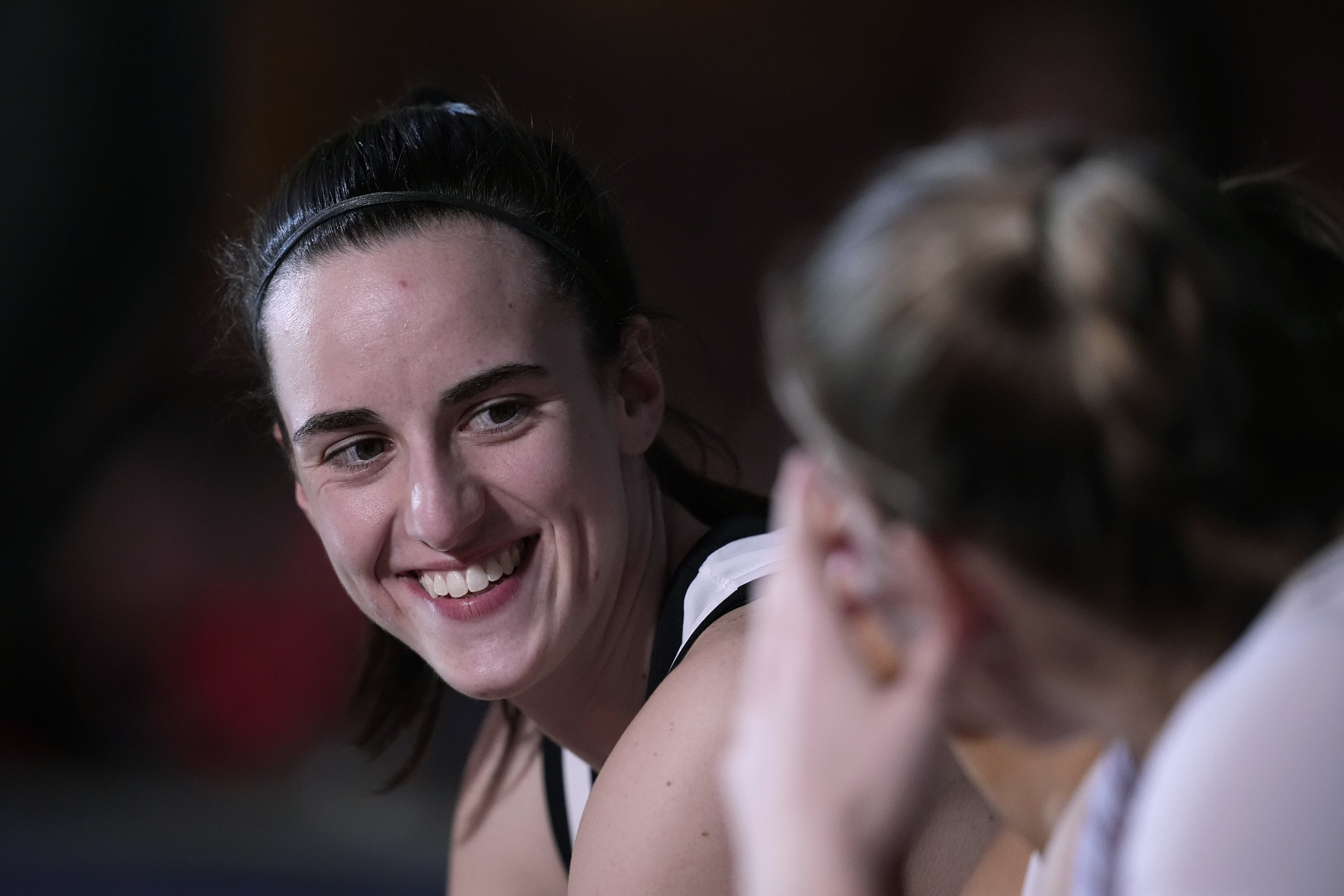 Iowa guard Caitlin Clark sits on the bench during player introductions before a second-round college basketball game against West Virginia in the NCAA Tournament, Monday, March 25, 2024, in Iowa City, Iowa. 