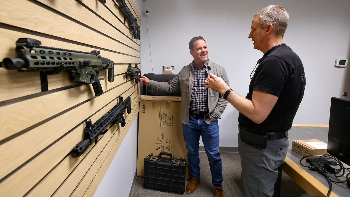 U.S. Senate candidate Brad Wilson meets with Alex Robinson, Robinson Armament Co. general manager, at Robinson Armament in North Salt Lake on Thursday.
