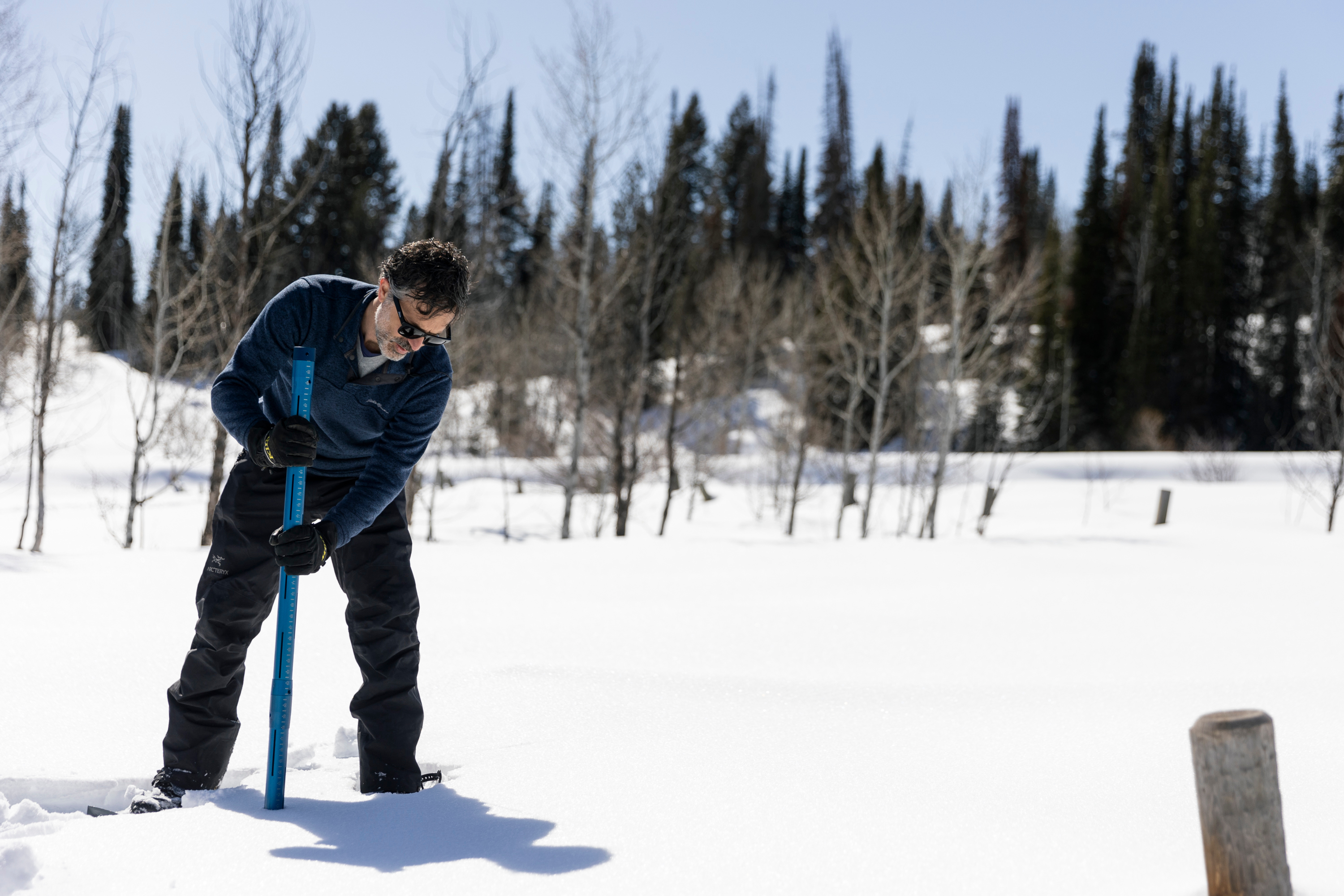Jordan Clayton, supervisor of the NRCS-Utah Snow Survey, demonstrates how to obtain a snow sample using Federal snow tubes at Utah’s first and oldest SNOwpack TELemetry and snow course site in Logan on March 8.