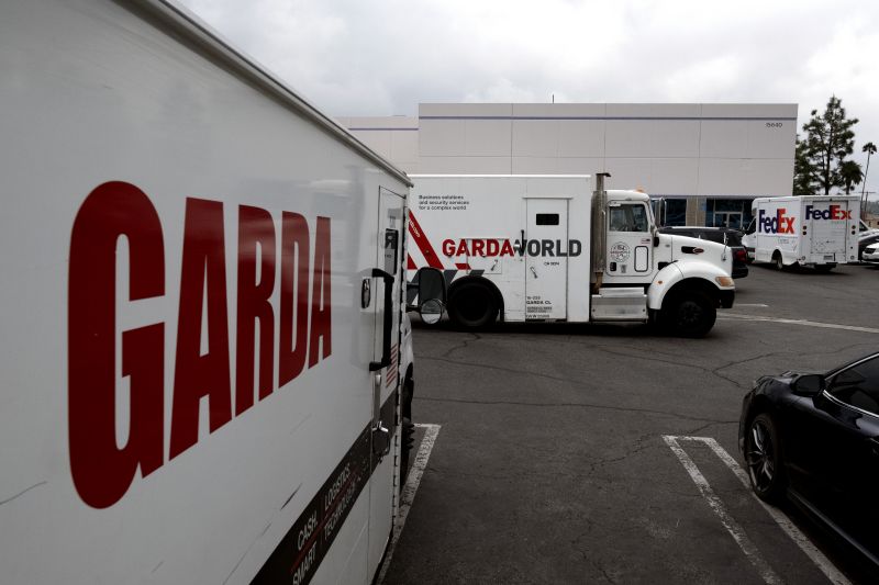 Armored trucks are parked outside the offices of GardaWorld in the Sylmar section of Los Angeles on Thursday. Thieves stole as much $30 million in an Easter Sunday burglary. 