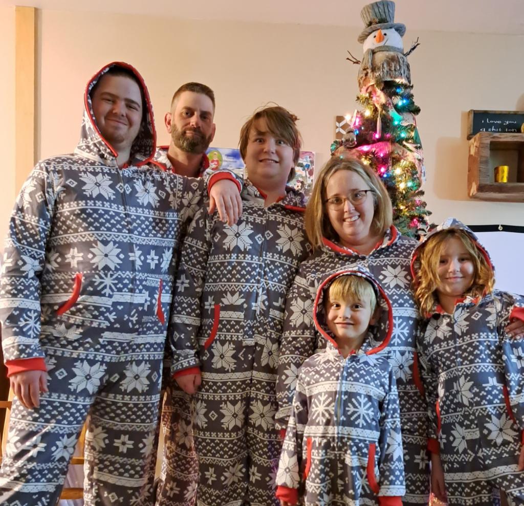 Kerttula family members wearing festive pajamas with dad Reino in the back.