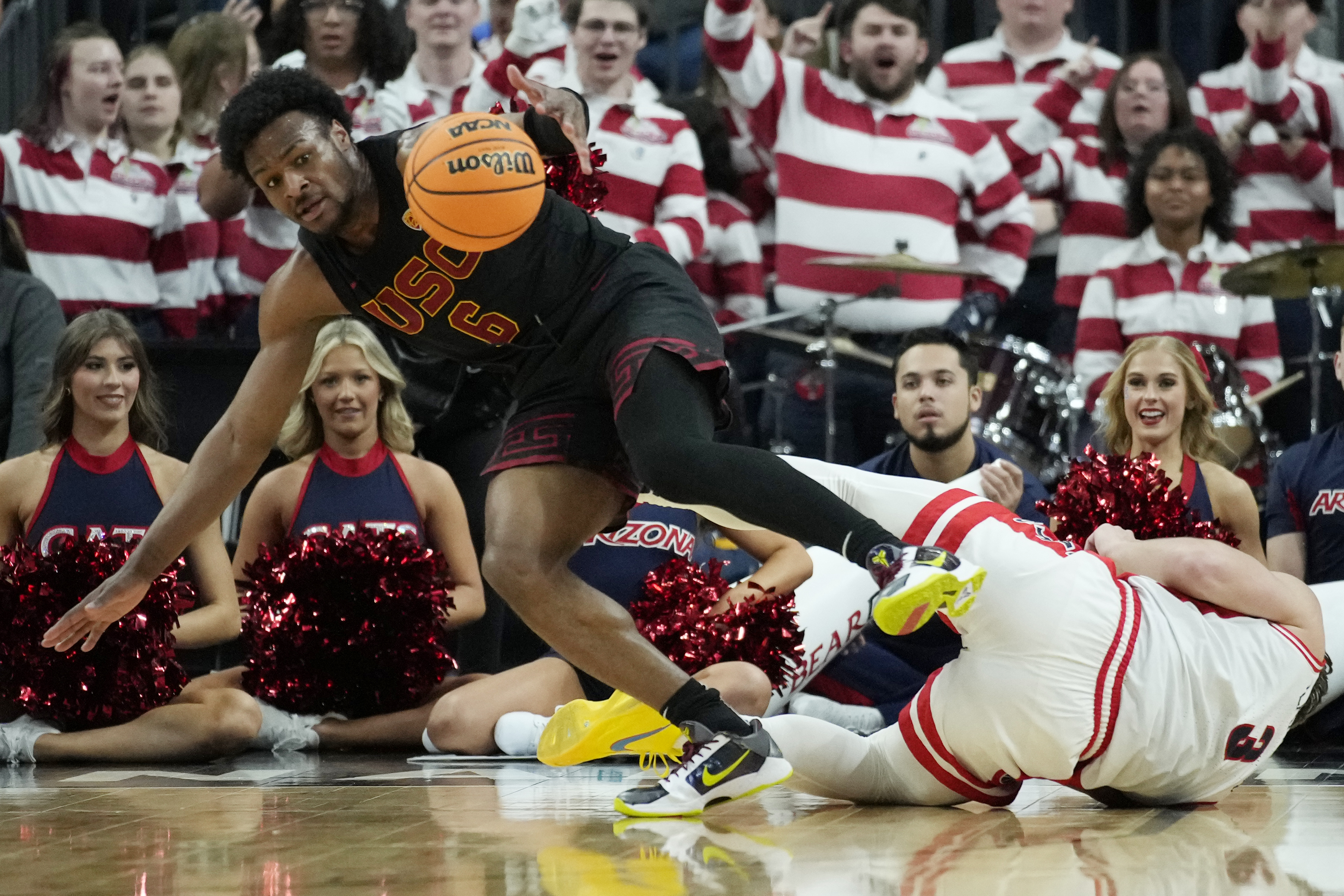 Southern California guard Bronny James (6) scrambles for the bal lwith Arizona guard Pelle Larsson (3) during the first half of an NCAA college basketball game in the quarterfinal round of the Pac-12 tournament Thursday, March 14, 2024, in Las Vegas. 