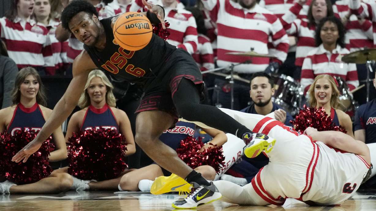 Southern California guard Bronny James (6) scrambles for the bal lwith Arizona guard Pelle Larsson (3) during the first half of an NCAA college basketball game in the quarterfinal round of the Pac-12 tournament Thursday, March 14, 2024, in Las Vegas.