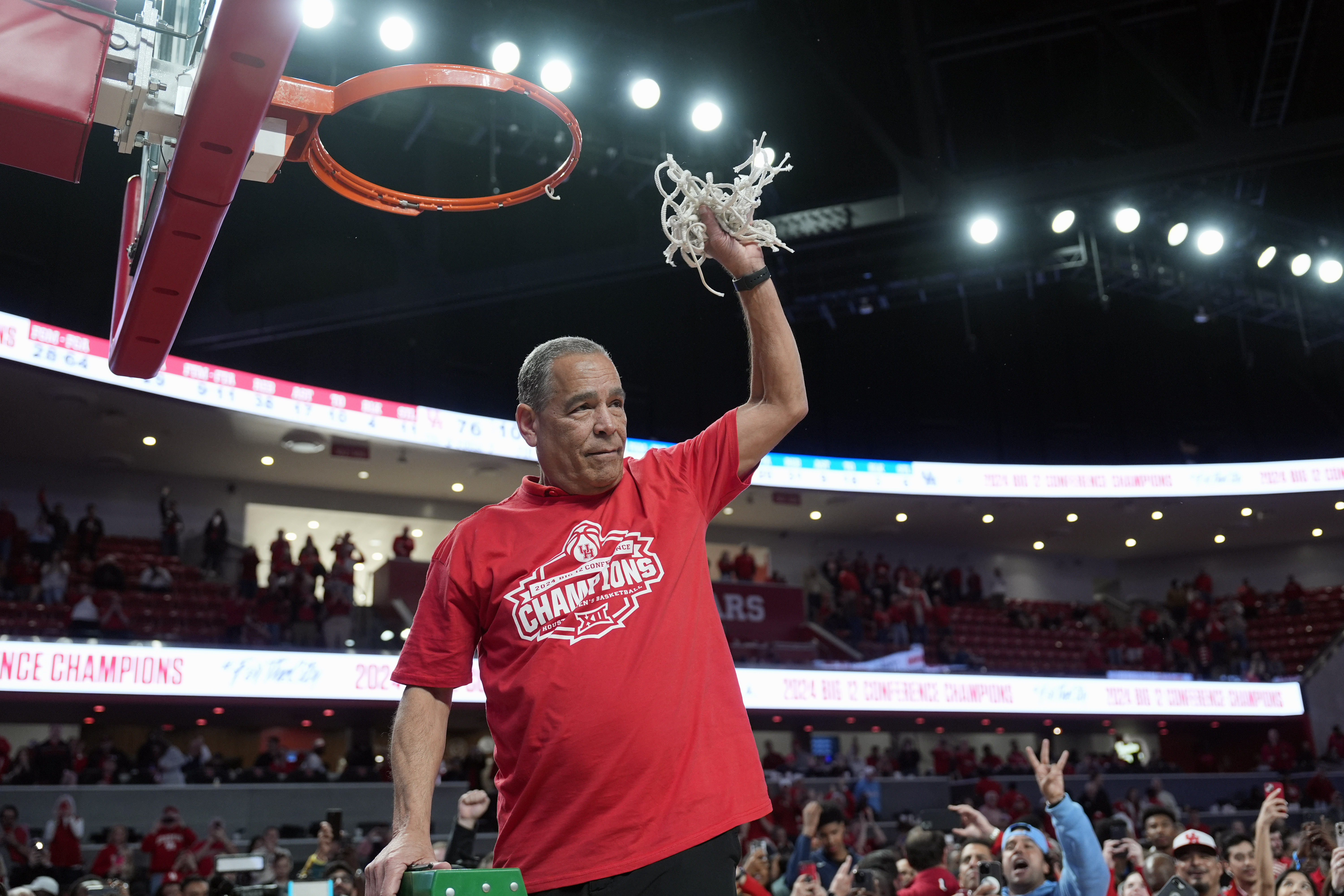Houston coach Kelvin Sampson cuts down the net after an NCAA college basketball game against Kansas Saturday, March 9, 2024, in Houston. Houston won 76-46 and finished the regular season as the Big 12 Conference Champions. 