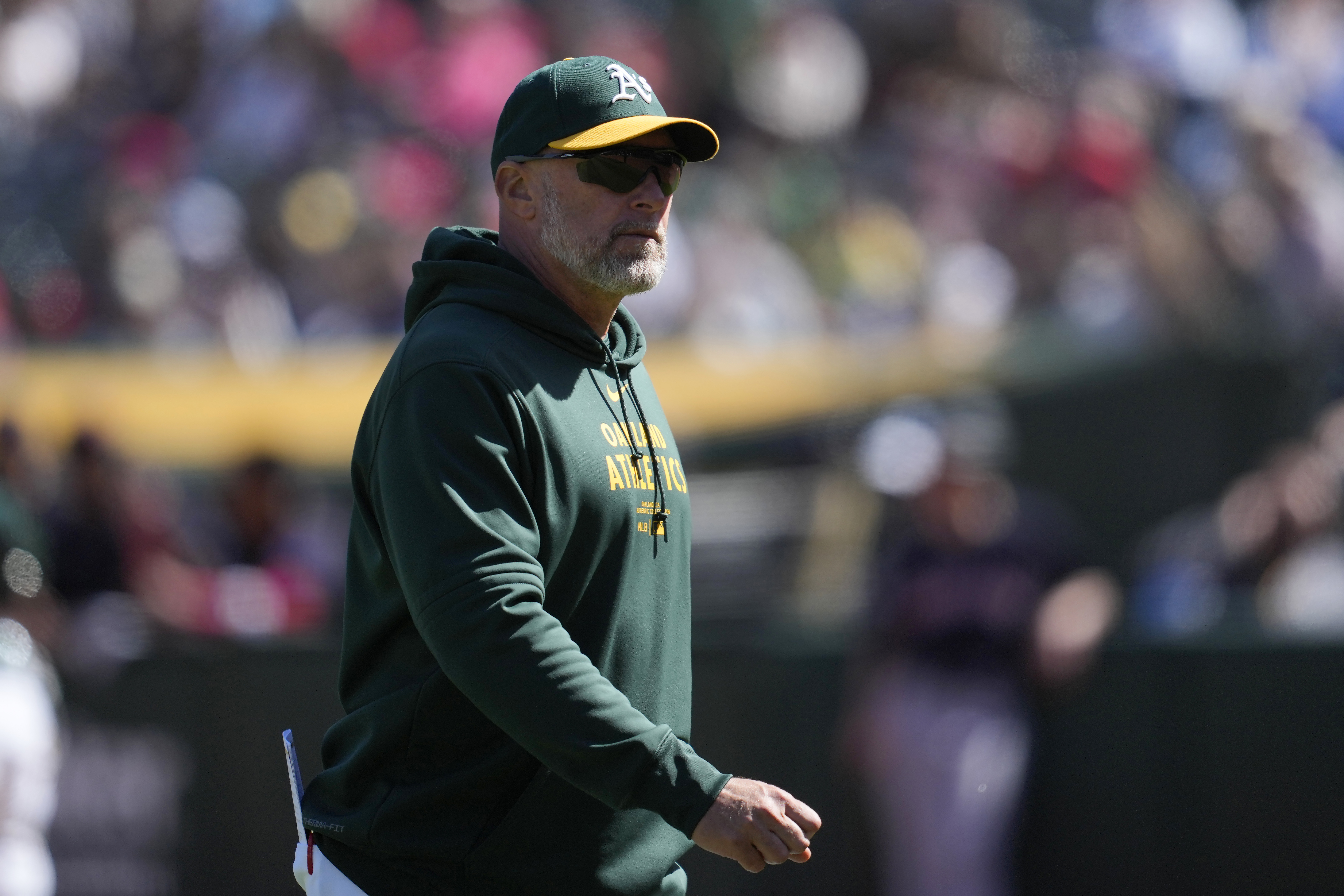 Oakland Athletics manager Mark Kotsay walks to the dugout after making a pitching change during the eighth inning of the team's baseball game against the Cleveland Guardians in Oakland, Calif., Sunday, March 31, 2024. 