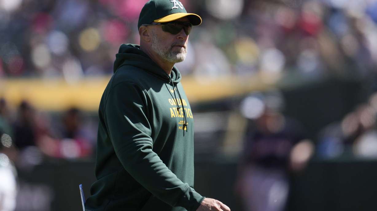 Oakland Athletics manager Mark Kotsay walks to the dugout after making a pitching change during the eighth inning of the team's baseball game against the Cleveland Guardians in Oakland, Calif., Sunday, March 31, 2024.