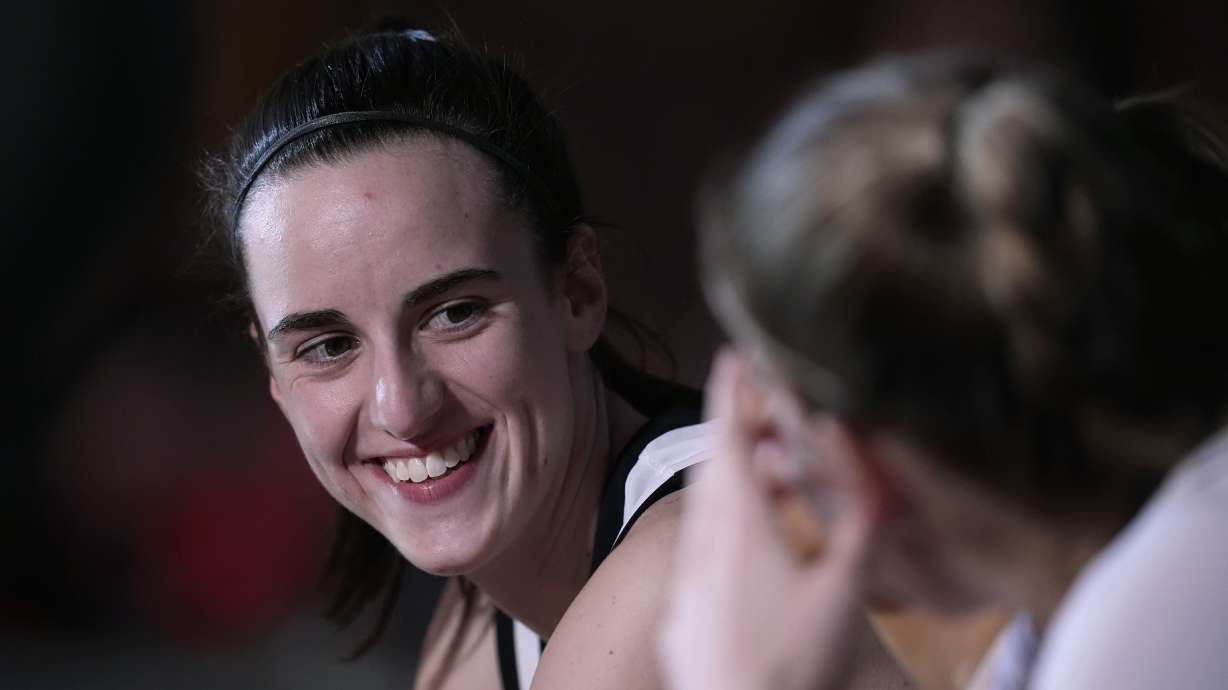 Iowa guard Caitlin Clark sits on the bench during player introductions before a second-round college basketball game against West Virginia in the NCAA Tournament, Monday, March 25, 2024, in Iowa City, Iowa.