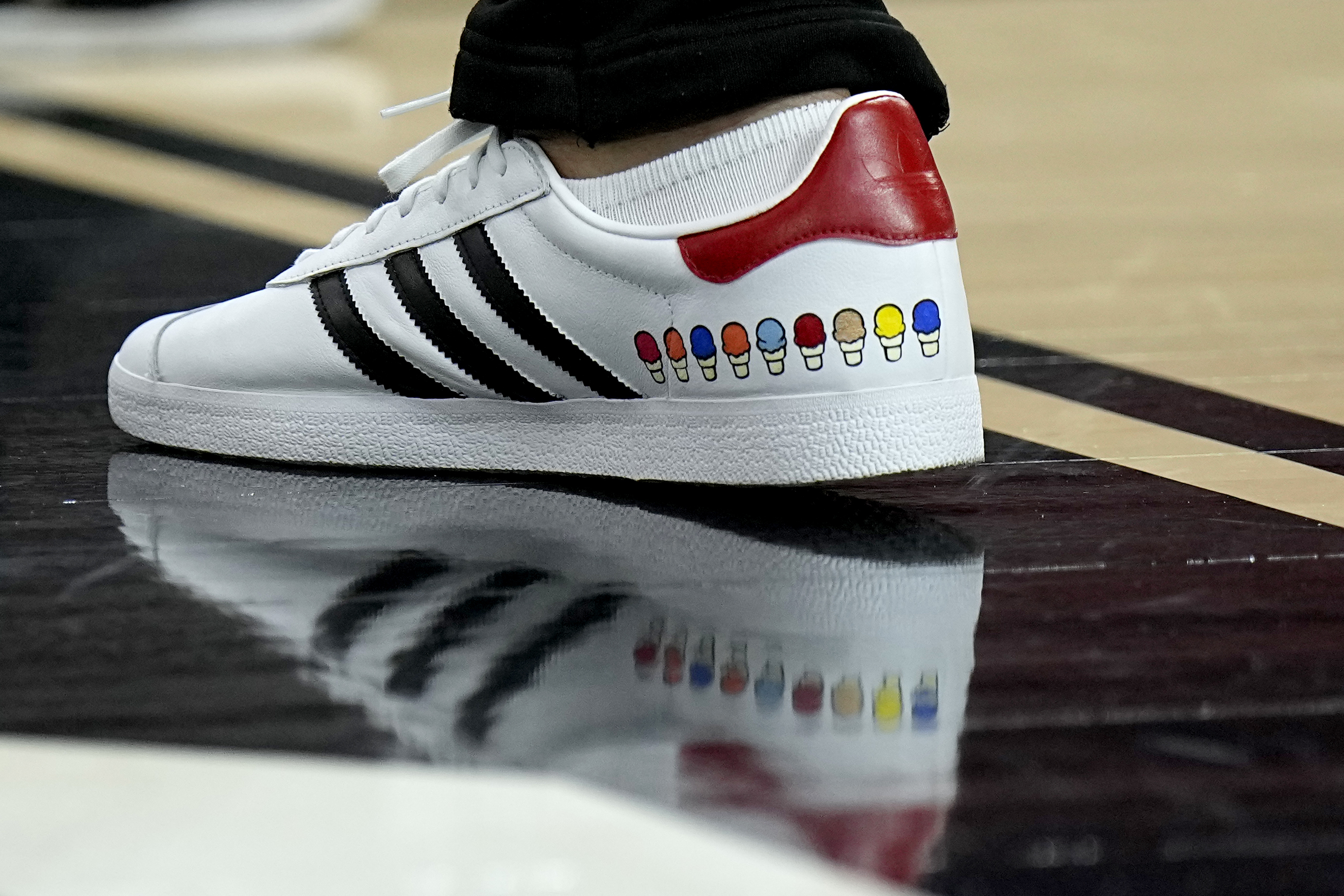 NC State head coach Kevin Keatts wears custom stitched shoes during practice ahead of a Final Four college basketball game in the NCAA Tournament, Friday, April 5, 2024, in Glendale, Ariz. North Carolina State plays Purdue. 
