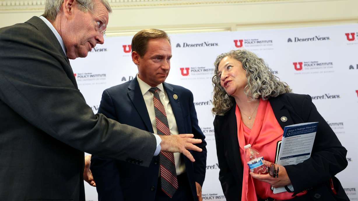 Former Gov. Michael O. Leavitt, Rep. Steve Eliason, R-Sandy, and Department of Health and Human Services Executive Director Tracy Gruber talk after a panel discussion at the Thomas S. Monson Center in Salt Lake City on Friday.
