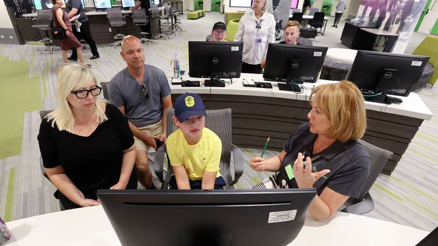 Vanessa Newton, left, Lee Newton and Brice Newton get help starting a FamilySearch account for Brice from Diane Gomm at The Church of Jesus Christ of Latter-day Saints’ Family History Library, now the FamilySearch Library, in Salt Lake City on July 6, 2021.