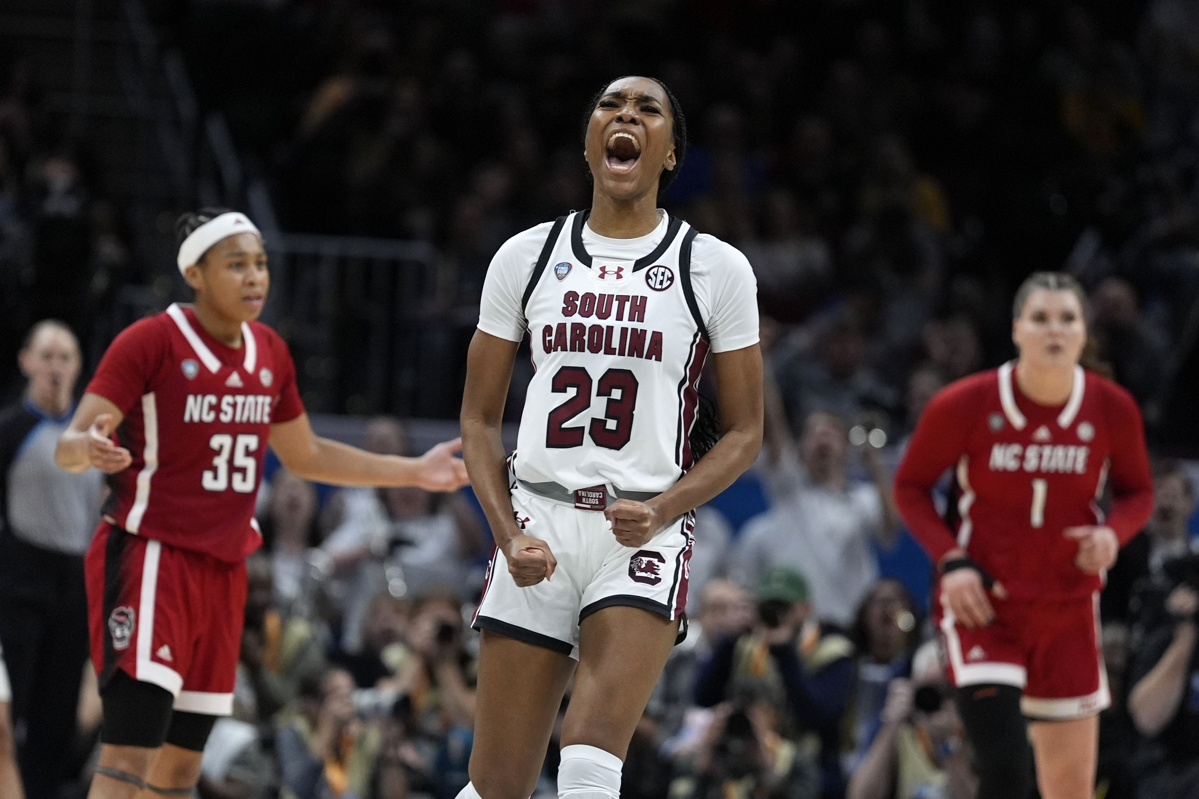 South Carolina guard Bree Hall (23) celebrates after making a three-point basket during the second half of a Final Four college basketball game against North Carolina State in the women's NCAA Tournament, Friday, April 5, 2024, in Cleveland. 