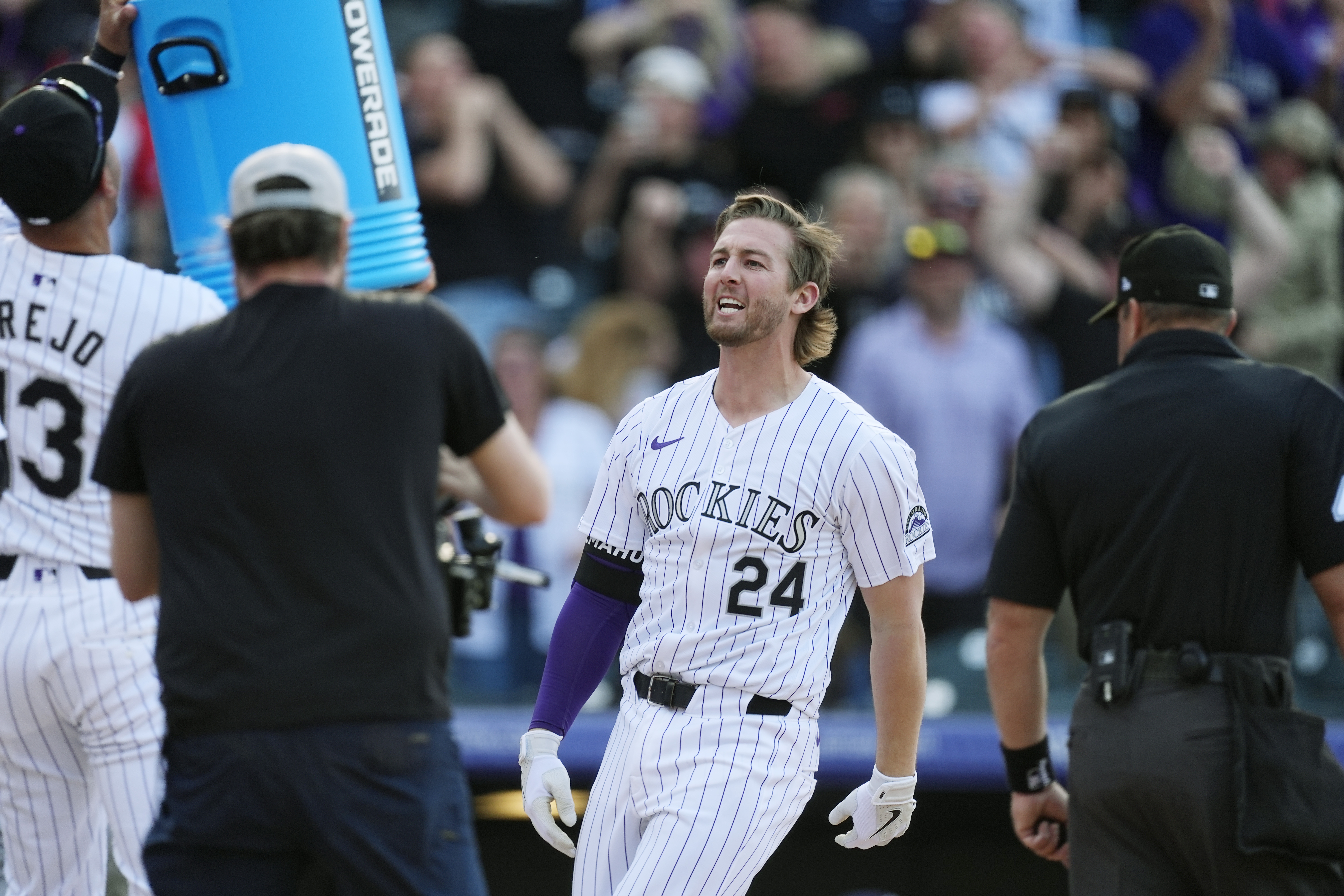 Colorado Rockies' Ryan McMahon arrives at the plate after hitting a grand slam off Tampa Bay Rays pitcher Jason Adam during the ninth inning of a baseball game Friday, April 5, 2024, in Denver.