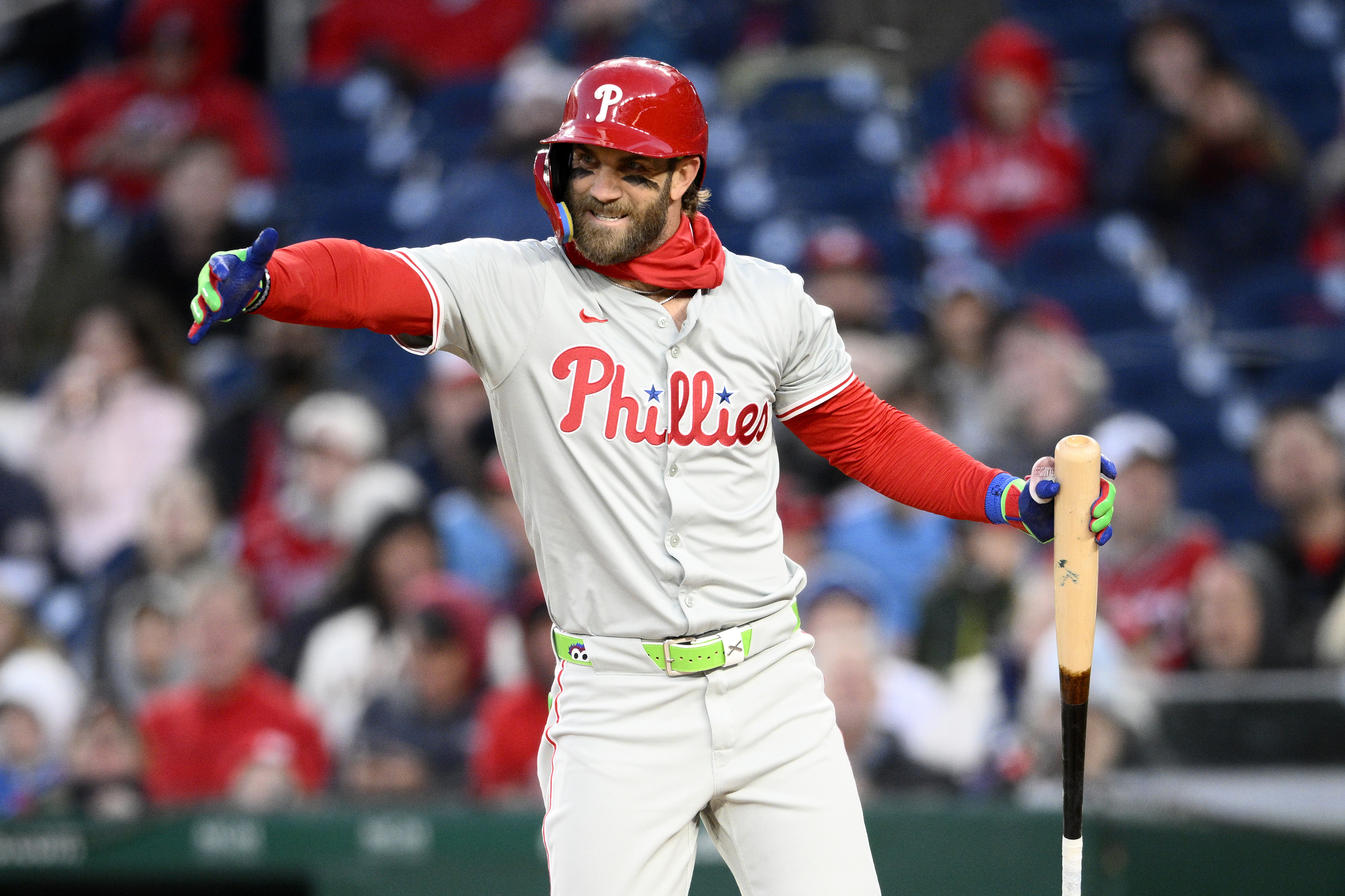 Philadelphia Phillies Bryce Harper gestures during his at-bat in the third inning of a baseball game against the Washington Nationals, Friday, April 5, 2024, in Washington. 