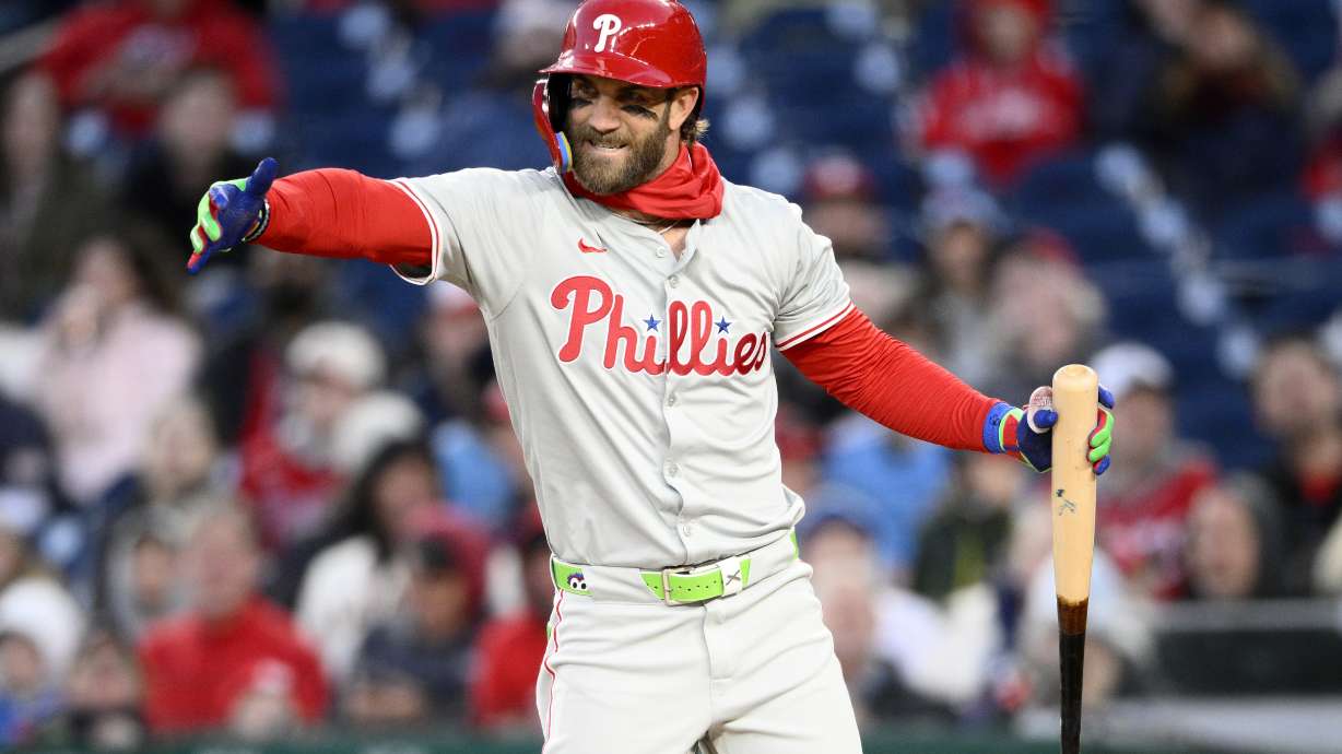 Philadelphia Phillies Bryce Harper gestures during his at-bat in the third inning of a baseball game against the Washington Nationals, Friday, April 5, 2024, in Washington.