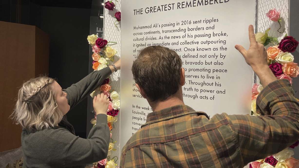 The story is scheduled to be released at 12:01 am ET Saturday. Here's a caption: Bess Goldy, left, helps arrange a display at the Muhammad Ali Center in Louisville, Ky., on Thursday, April 4, 2024. Goldy is curator of a new exhibit chronicling the outpouring of emotions in Ali's hometown following the boxing champion's death in 2016.
