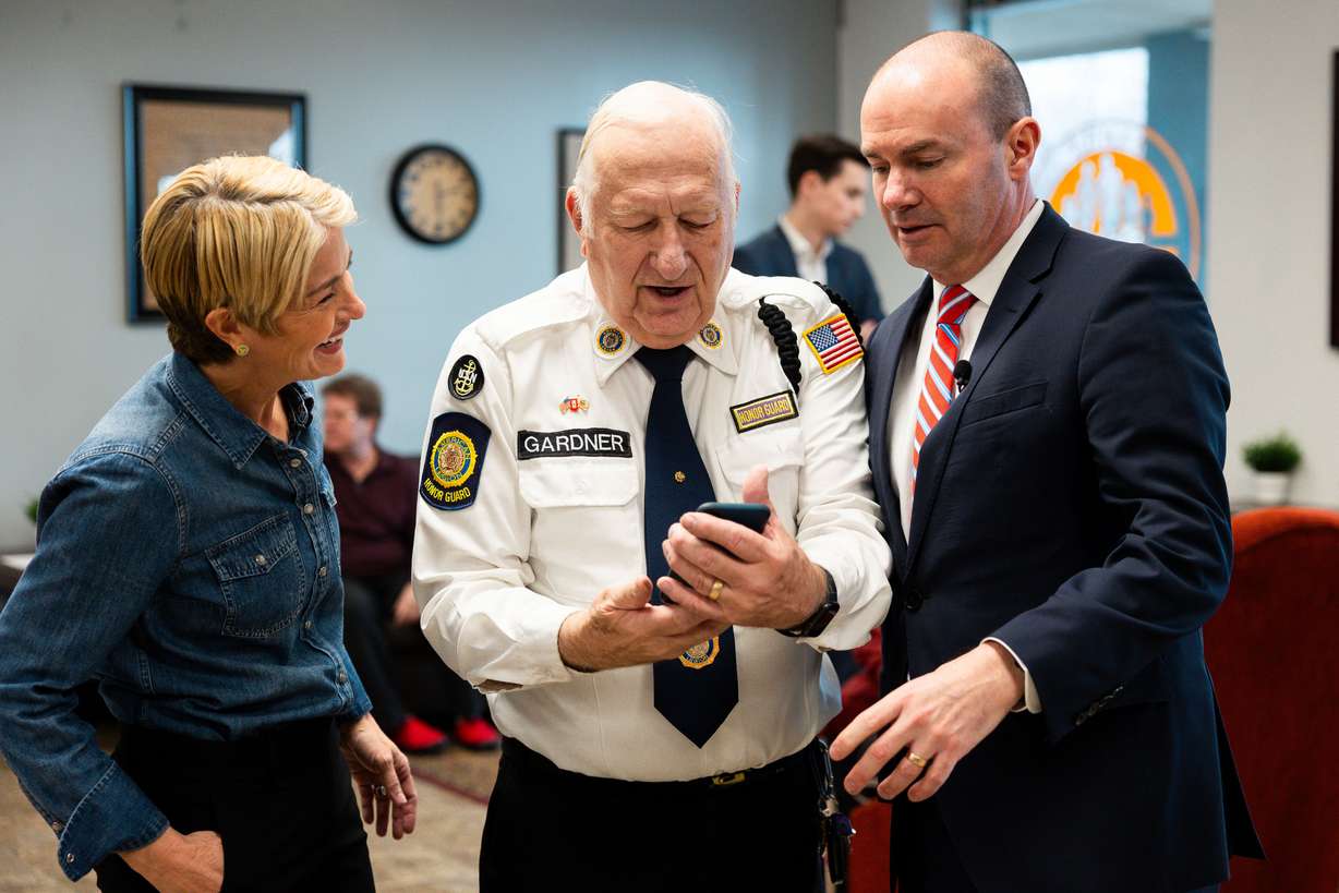 From left, U.S. Senate Candidate Carolyn Phippen, Rodney Gardner and Sen. Mike Lee look down as Gardner prepares to take a selfie before a town hall at Kimber Academy in Lindon, Utah, on Friday, April 5, 2024.