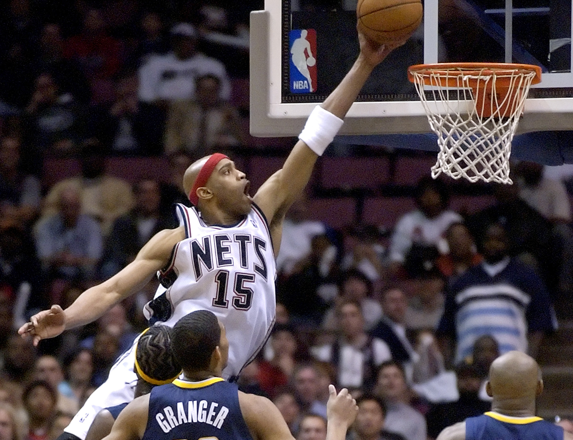 FILE - New Jersey Nets' Vince Carter (15) dunks as Indiana Pacers' Danny Granger (33), Jermaine O'Neal and Anthony Johnson (8) look on in the final minute of first round NBA playoffs basketball Tuesday night, May 2, 2006 in East Rutherford, N.J. Carter was elected to the Naismith Basketball Hall of Fame, Saturday, April 6, 2024. The 13-member class of 2024 will be enshrined into the Hall of Fame in Springfield, Massachusetts, in August,